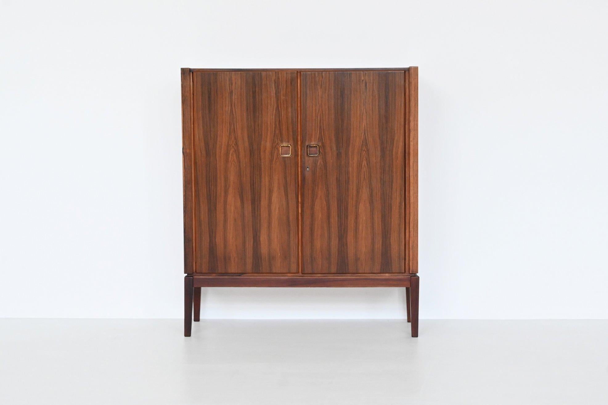 Beautiful buffet manufactured by Topform, The Netherlands 1960. This very nice slim shaped cabinet is made of beautifully grained veneered rosewood with solid legs. Even the inside door panels are beautiful flamed. It has two doors with four shelves