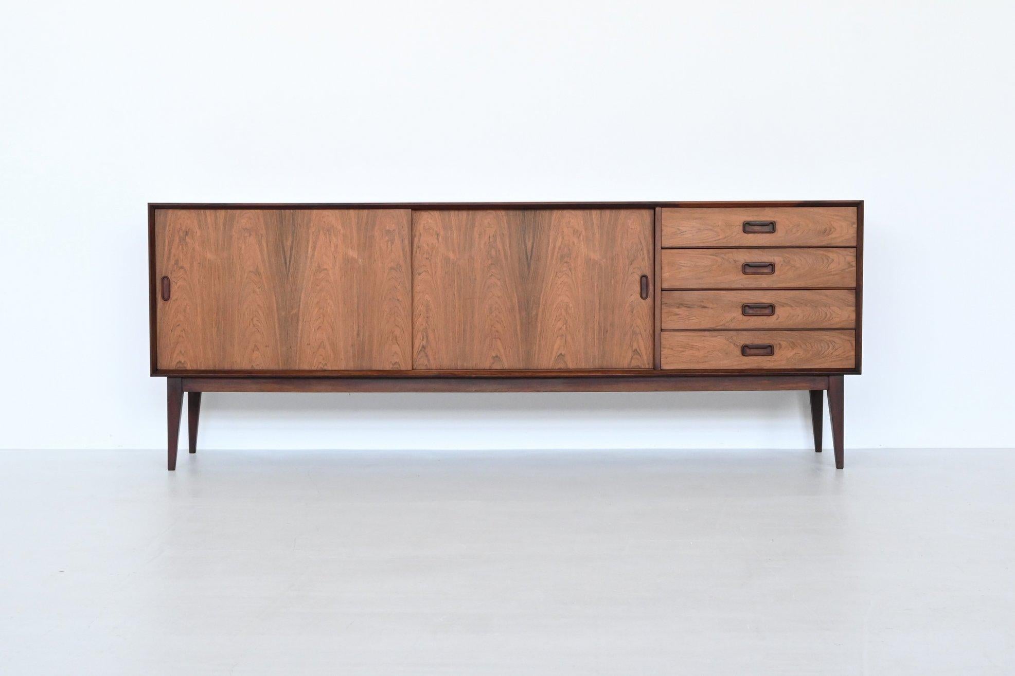 Beautiful large sideboard manufactured by Topform, The Netherlands 1960. This very nice shaped sideboard is made of beautifully grained veneered rosewood with solid legs. It has two sliding doors with shelves behind and four drawers. Very nice