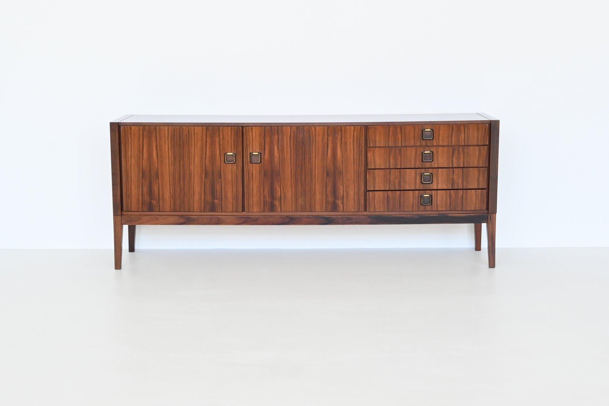 Beautiful sideboard or credenza manufactured by Topform, The Netherlands 1960. This very nice slim shaped sideboard is made of beautifully grained veneered rosewood with solid legs. Even the inside door panels are beautiful flamed. It has two doors
