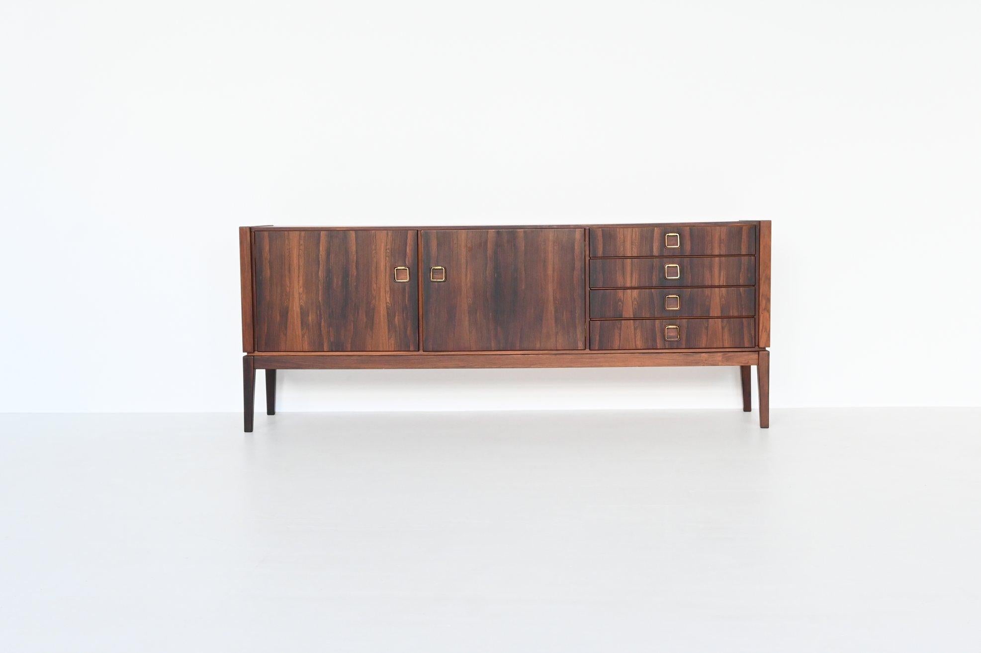 Beautiful sideboard or credenza manufactured by Topform, The Netherlands 1960. This very nice slim shaped sideboard is made of beautifully grained veneered rosewood with solid legs. Even the inside door panels are beautiful flamed. It has two doors