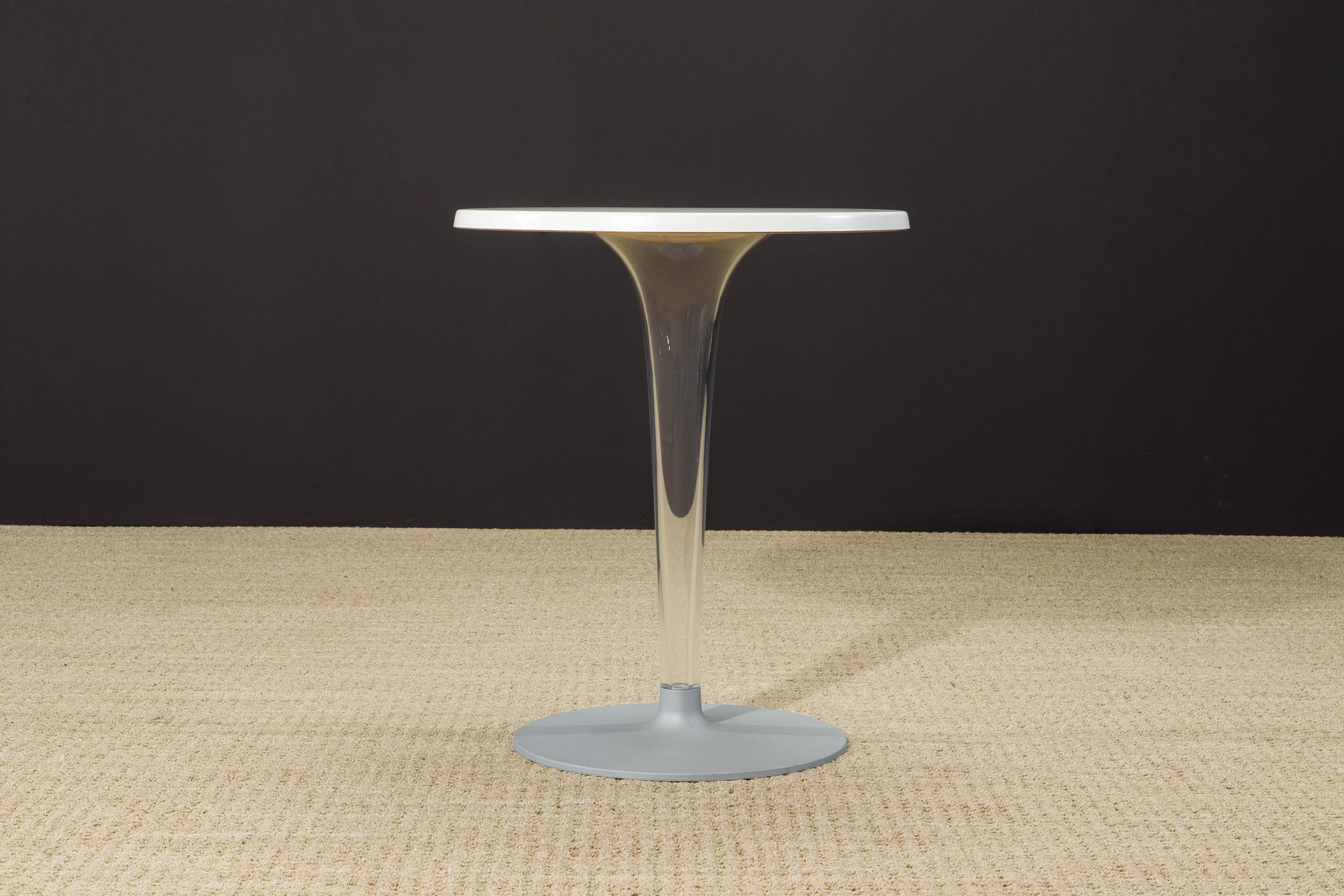A sleek and sculptural café or bistro table designed by Philippe Starck with Eugeni Quitllet for Kartell, this piece is part of the iconic 'TopTop' series. Featuring a white round top, a transparent central leg in acrylic with subtle fluting, and a