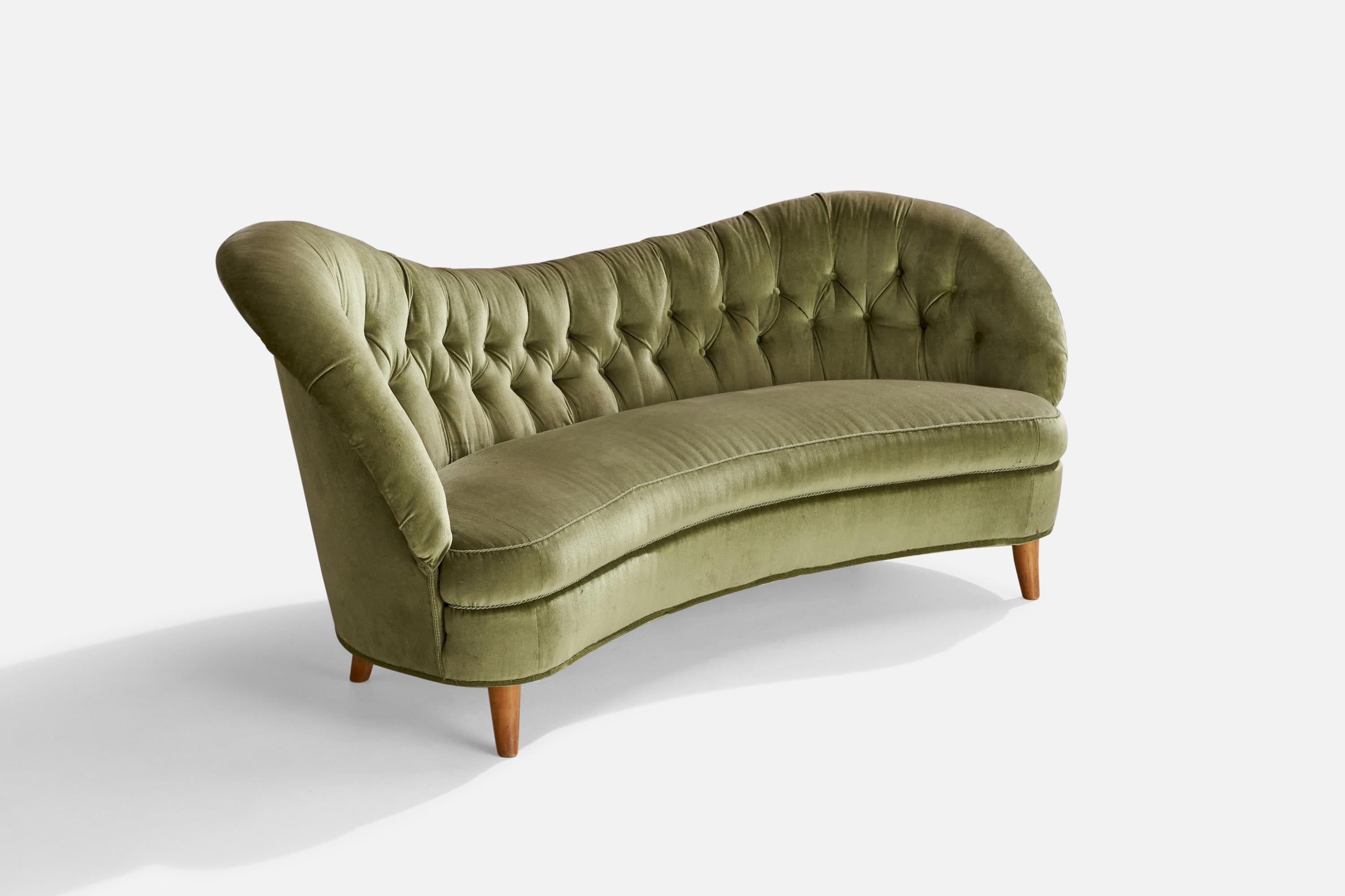 An organic wood and green velvet sofa, designed by Tor Wolfenstein and produced by Ditzingers, Sweden, c. 1940s.

Seat height: 17.5”
