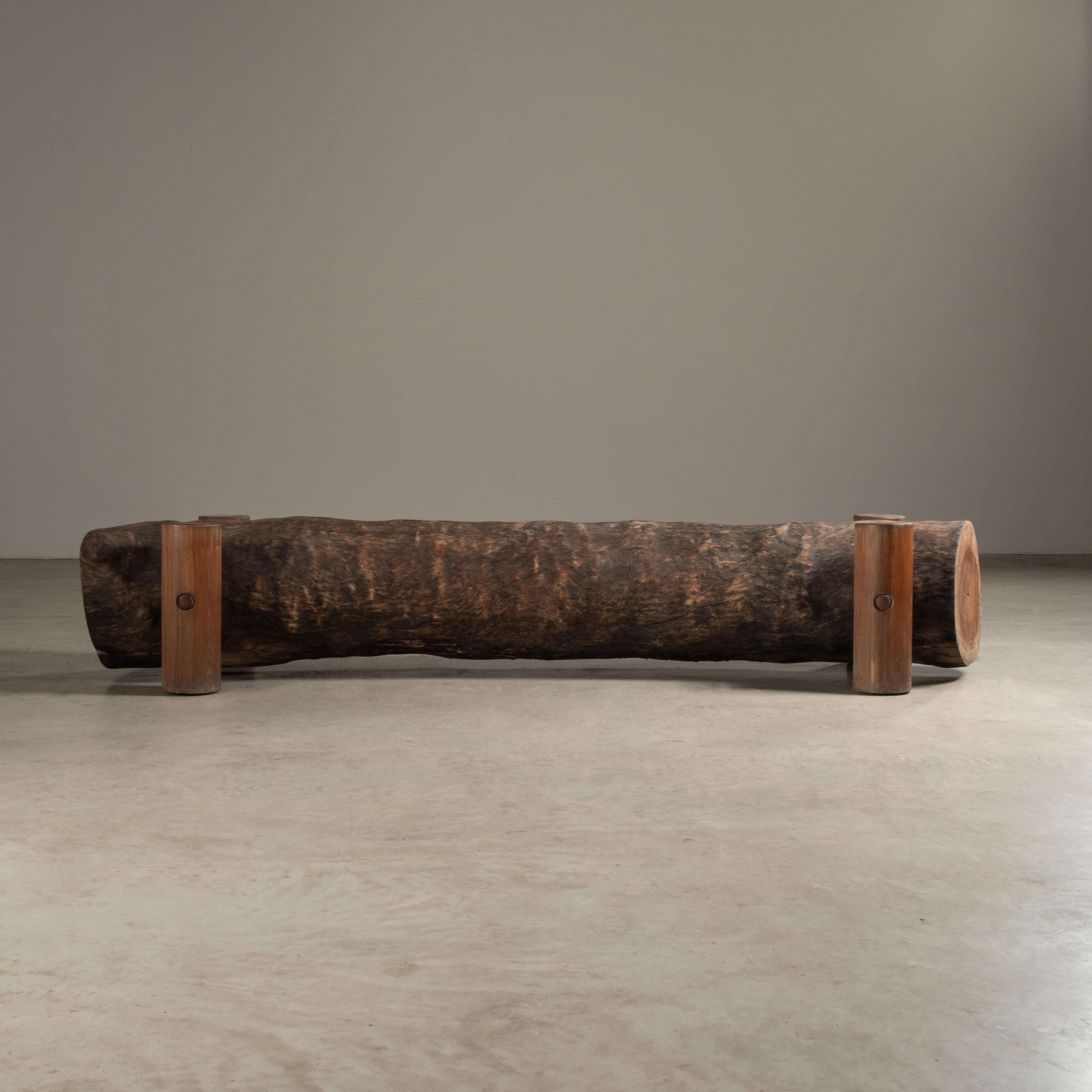 The Tora bench, designed by Zanini, is a fine example of contemporary design that celebrates the inherent beauty and form of natural materials. The bench is distinguished by its organic and robust appearance, which is achieved through the use of a