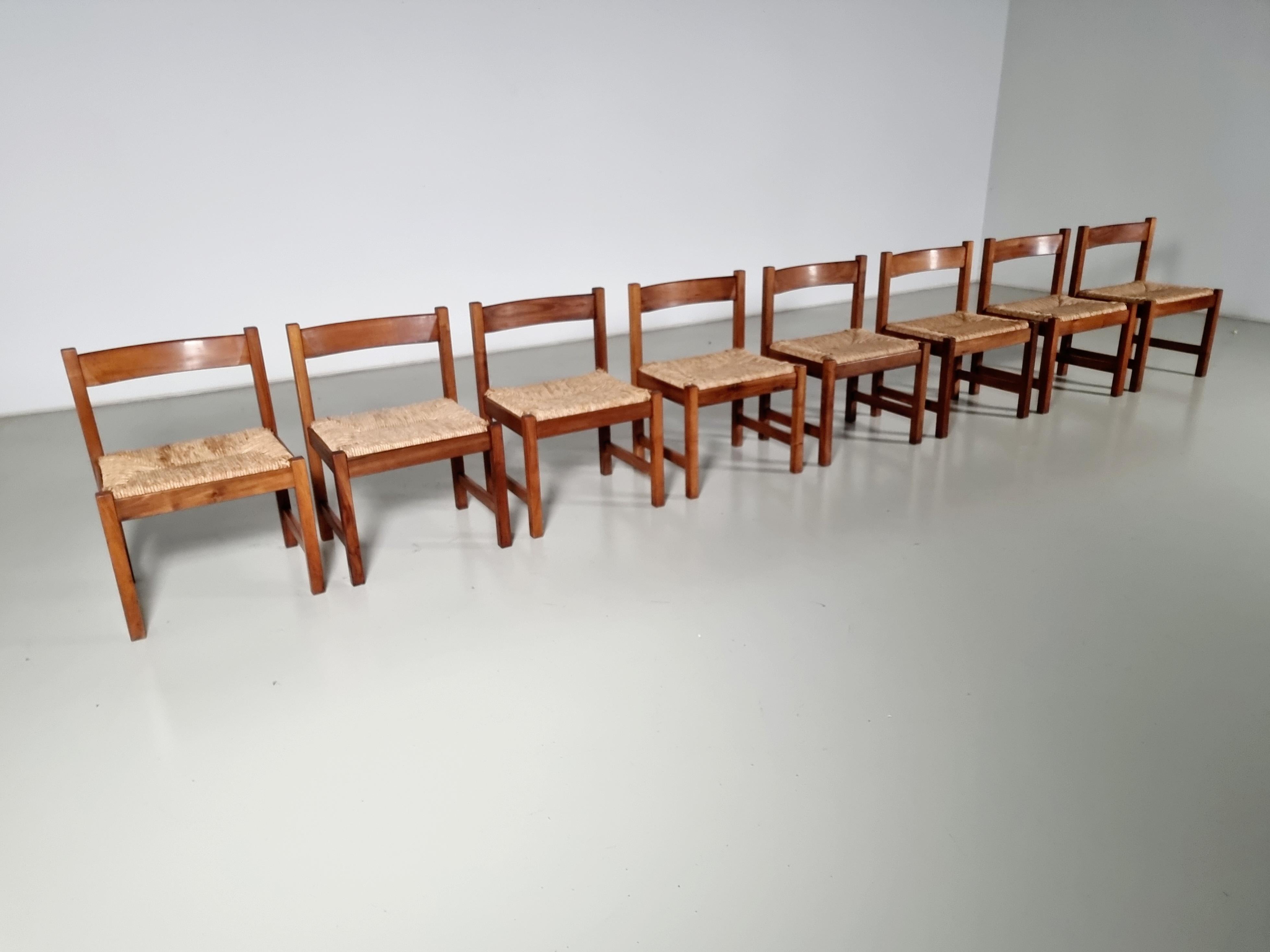 Set of 8 dining chairs from the Torbecchia series, designed by Giovanni Michelucci for Poltronova in 1964.

Solid walnut structure with seats upholstered in rush. The solid wood chairs have gained a stunning patina through the years. The woven rush
