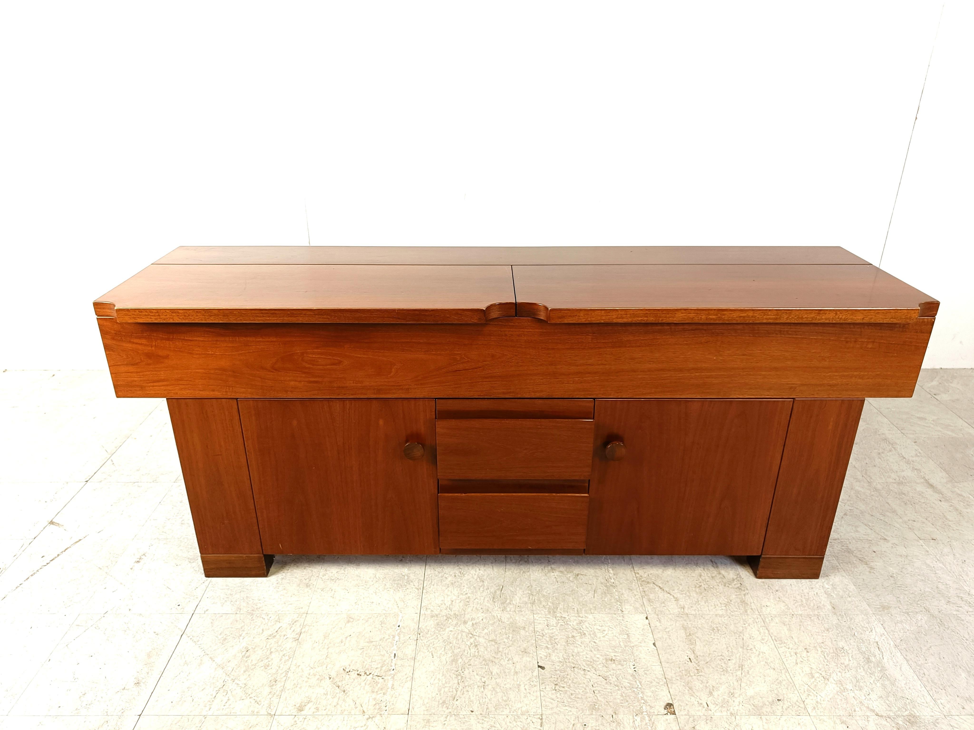 Rare mid century sideboard designed by Giovanni Michelucci  for Poltronova model 'torbecchia'.

this walnut sideboard has two unique folding tops, 2 regular doors and 2 central drawers

The signature of Giovanni Michelucci is visible on a sideboard