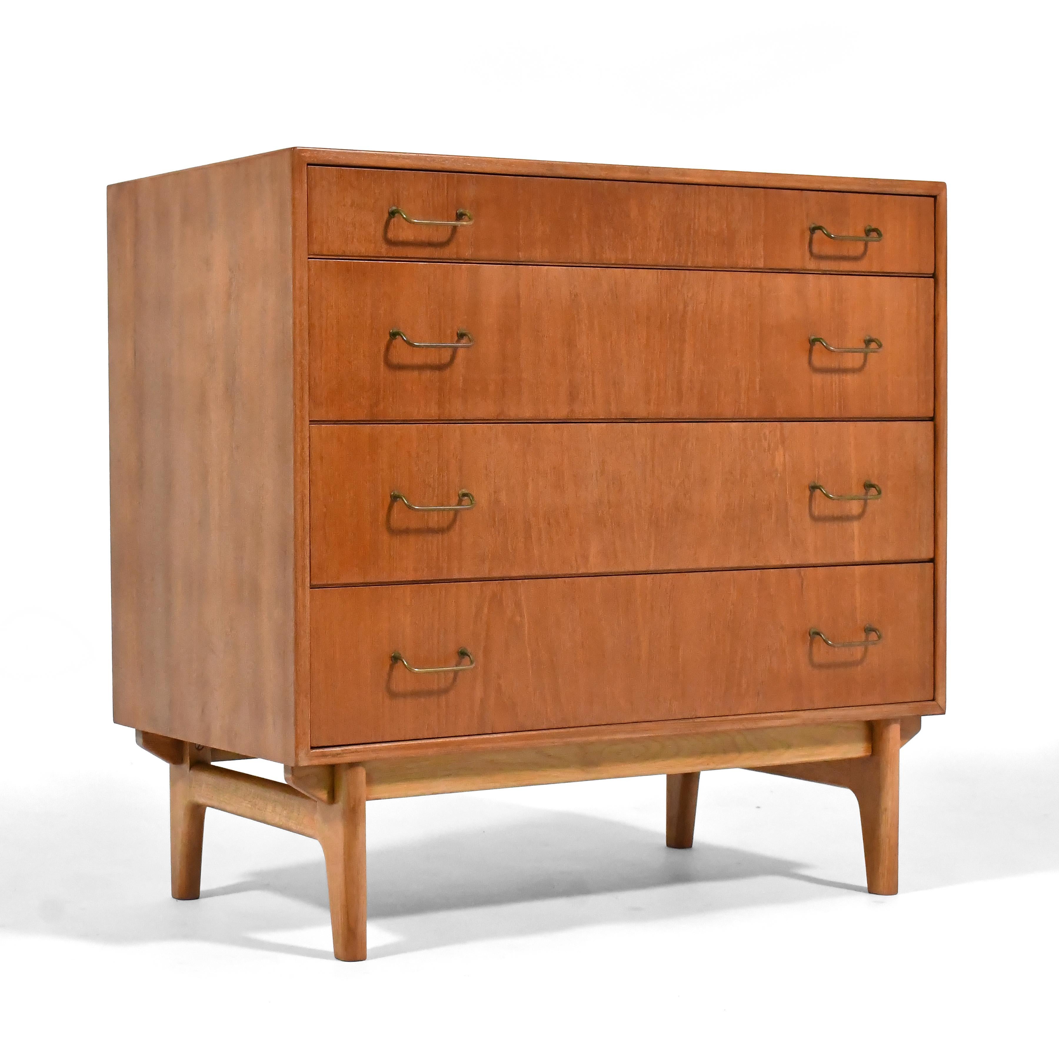 This beautiful Danish modern dresser in teak and oak by Torben Strandgaard is finely crafted by Møbelfabriken Falster and beautifully detailed with a chassis base and brass wire pulls. In additional to this smaller four drawer dresser, we have a