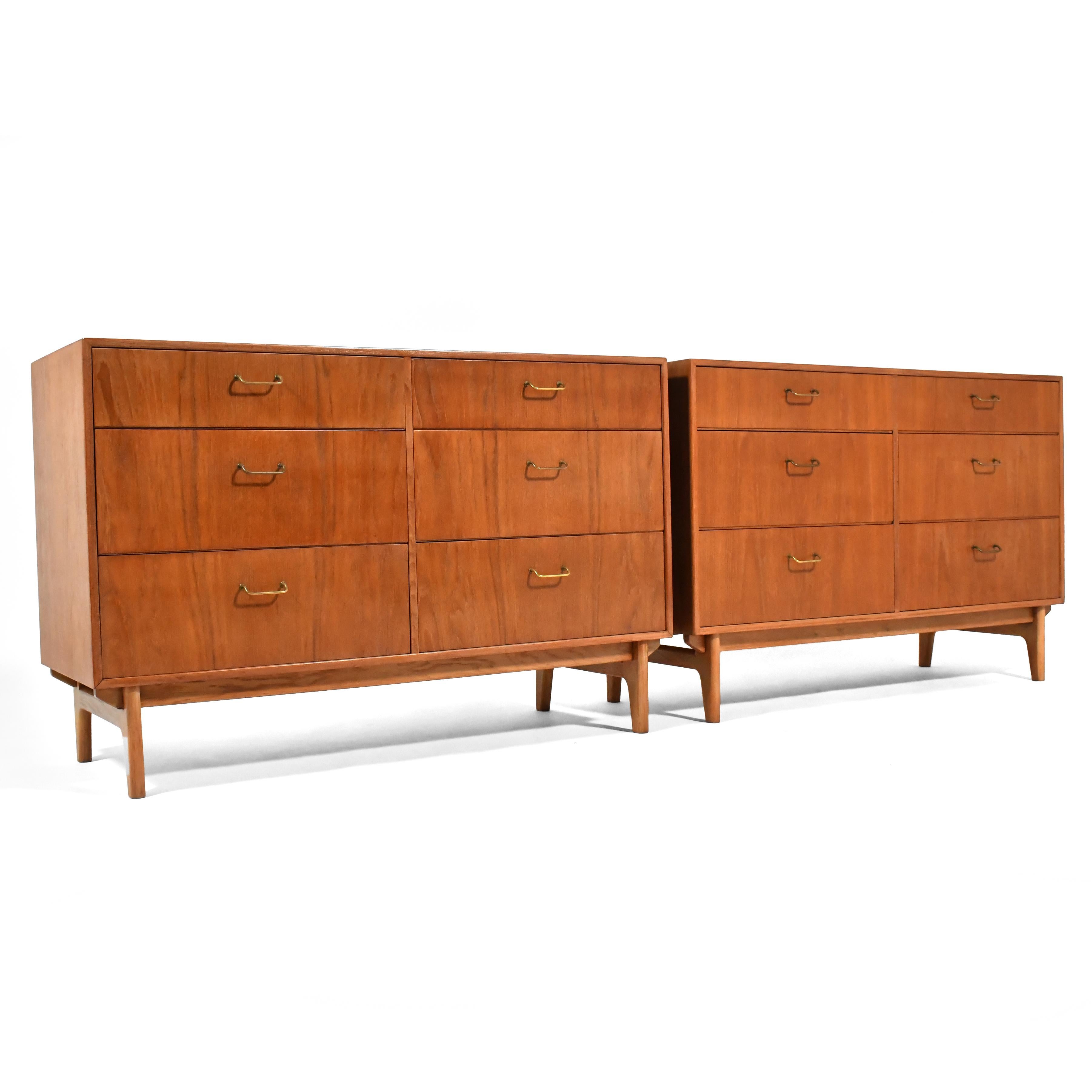 These beautiful Danish modern dressers in teak and oak by Torben Strandgaard were finely crafted by Møbelfabriken Falster and are beautifully detailed with a chassis base and brass wire pulls. 
In additional to this matched pair of dressers, we have