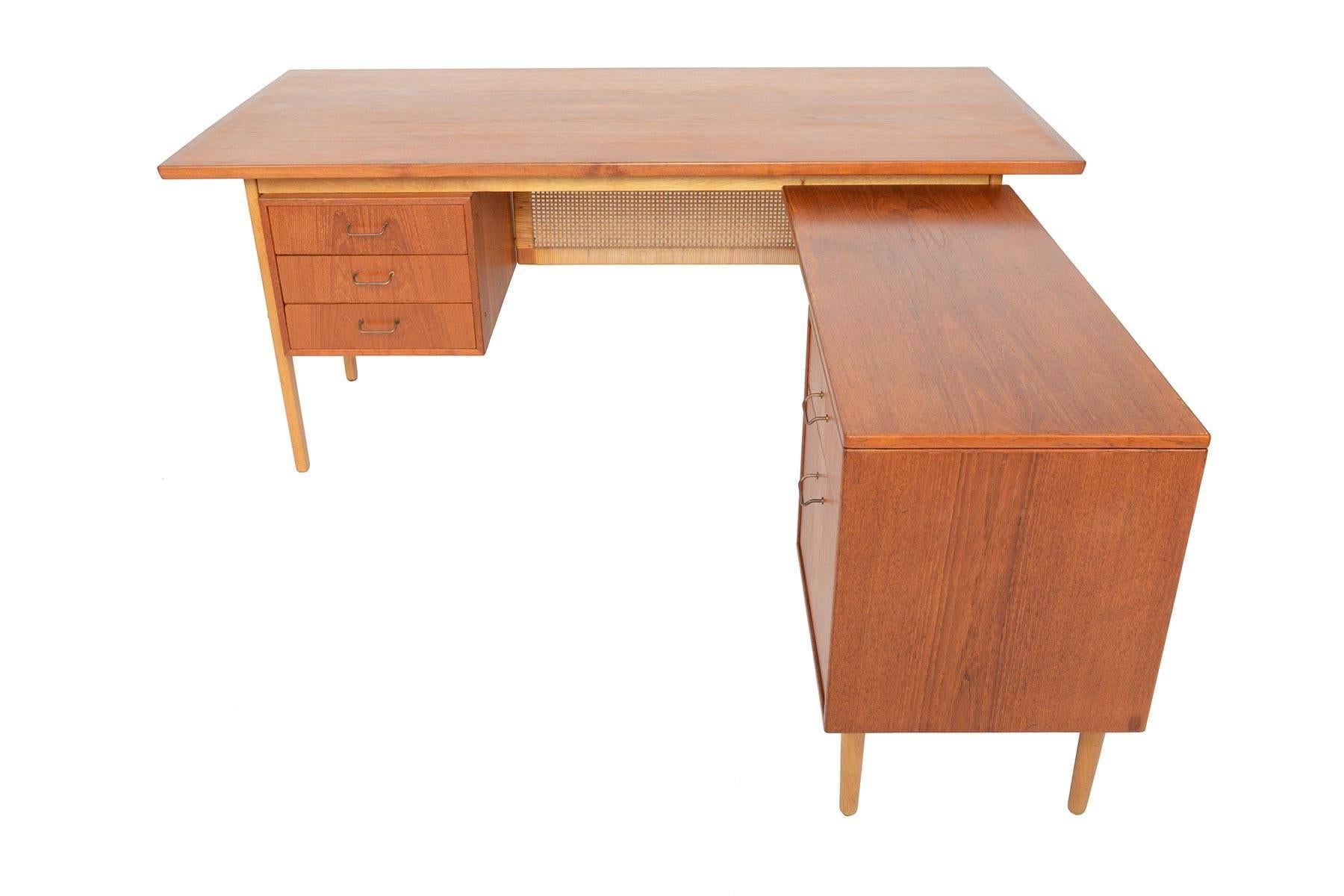 This remarkably well- preserved Danish modern executive desk was designed by Torben Strandgaard for Falster Møbelfabrik in the 1960s. This large desk features a detachable return on the right and provides a drawer and file cabinet. The large teak