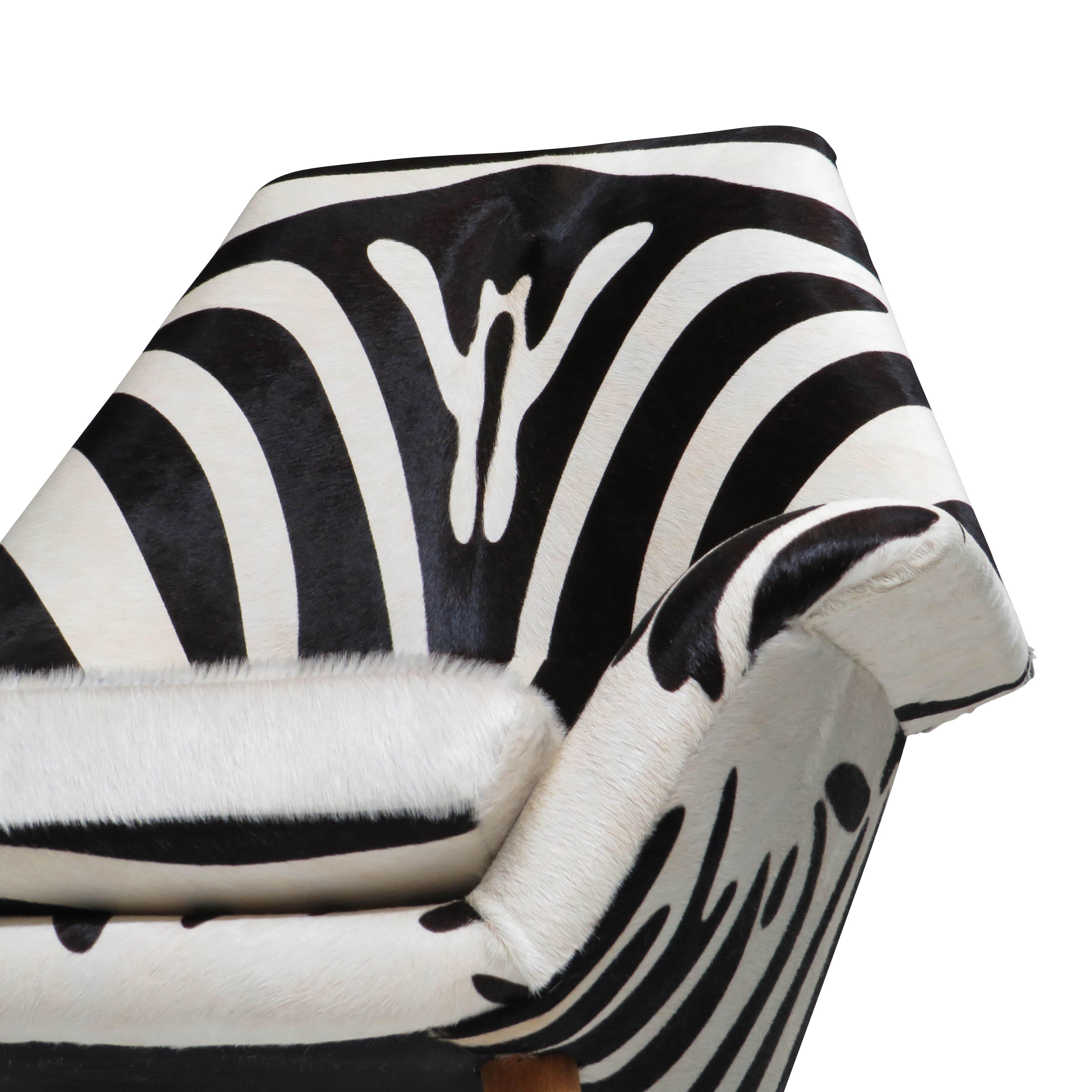 Mid-century Scandinavian high-back lounge chair designed by Torbjorn Afdal for Brusko, Bjarne Hansen Circa 1955, Norway. Crafted of a solid wood frame with flareds arms and newly upholstered in zebra stamped hair-on cow hide leather. Raised on solid