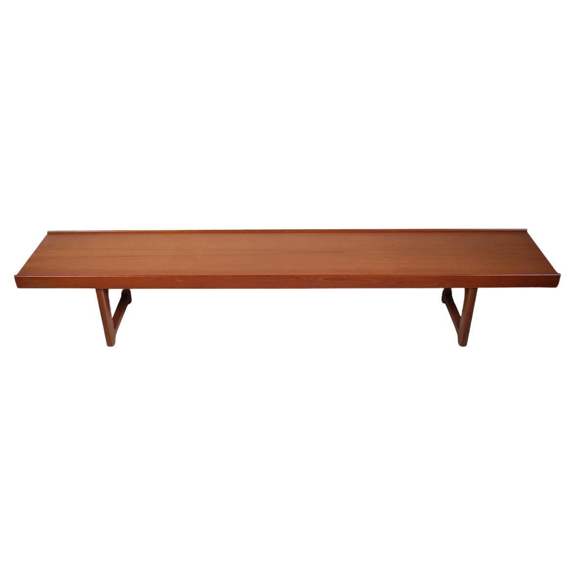 Long Torbjorn Afdal solid Teak Table, Bench by Bruksbo Mellenstrands Norway. Featuring a longer lower lipped rectangular framework in smoothly grained Teak, with Steel supported legs. Sturdy. Balanced. Versatile.  Made in Norway.  With label to