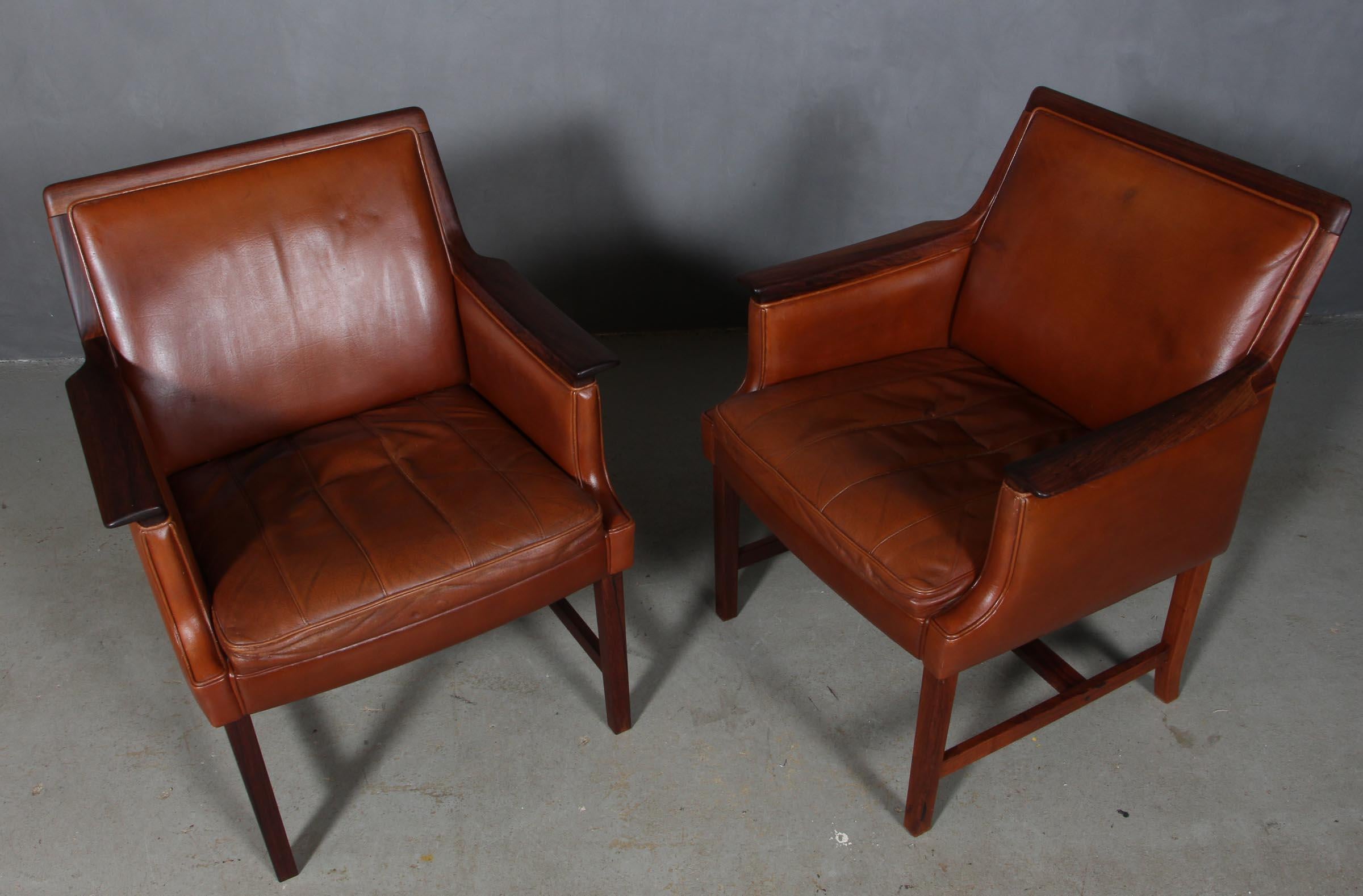 Torbjörn Afdal for Bruksbo pair of armchairs with original patinated leather.

Frame of rosewood.

Model Minerva, made by Bruksbo, Norway, 1960s.
