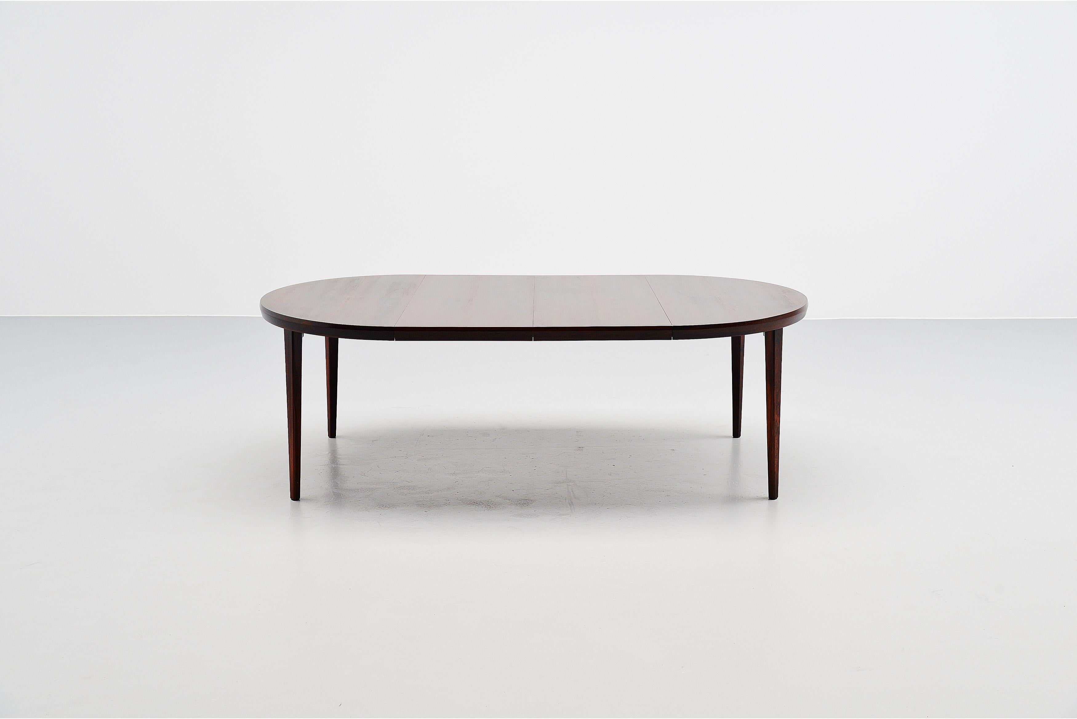 Beautiful quality dining table designed by Torbjorn Afdal and manufactured by Nejestranda, Norway 1960. The table has solid rosewood legs very nice shaped and rosewood veneer top. The table can be used as round or oval table, easy to extend using