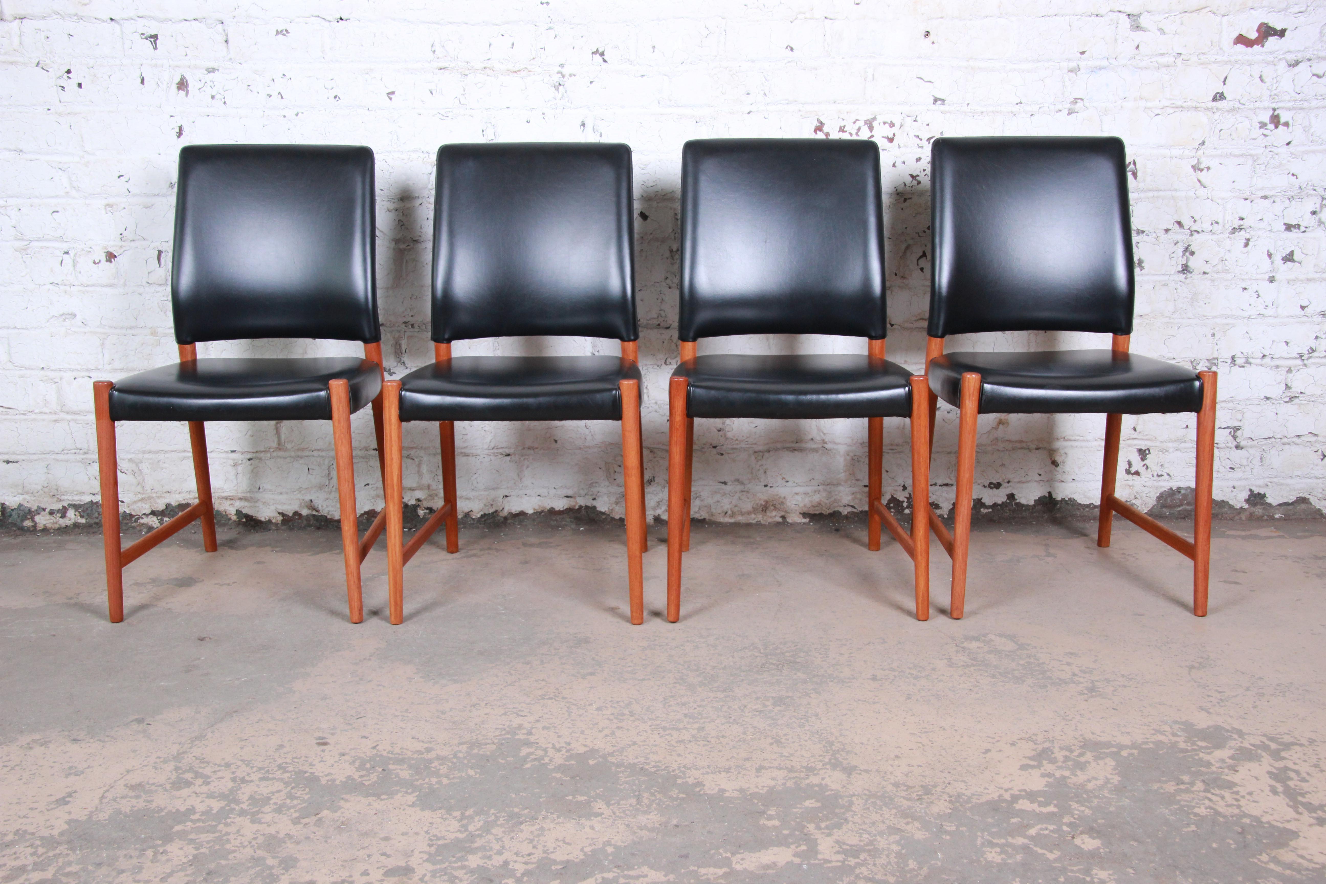 A gorgeous set of four midcentury Danish modern dining chairs designed by Torbjorn Afdal for Nesjestranda Møbelfabrik of Norway. The chairs feature solid teak frames and beautiful black leather upholstery. Stamped 