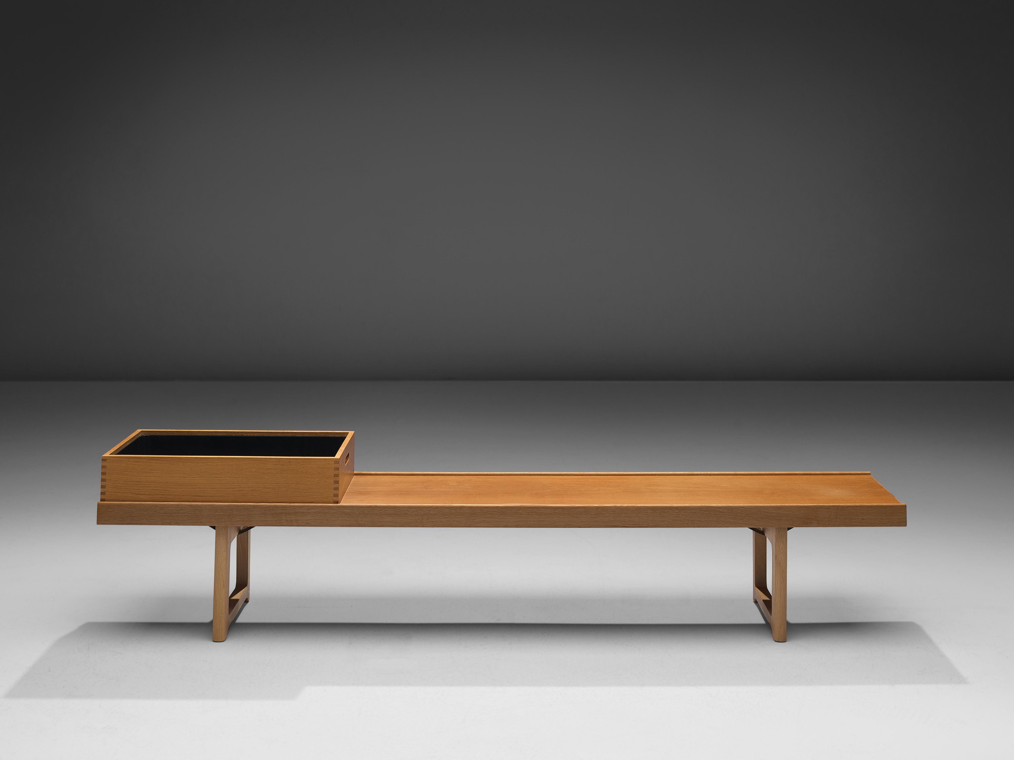 Torbjørn Afdal for Burksbo Mellemstrands Trevareindistri AS, 'Krobo' bench or side table, oak, metal, Norway, 1960s

This iconic bench or coffee table by Afdal is executed in oak and comes with one box that can be used as a tray too. Two legs with