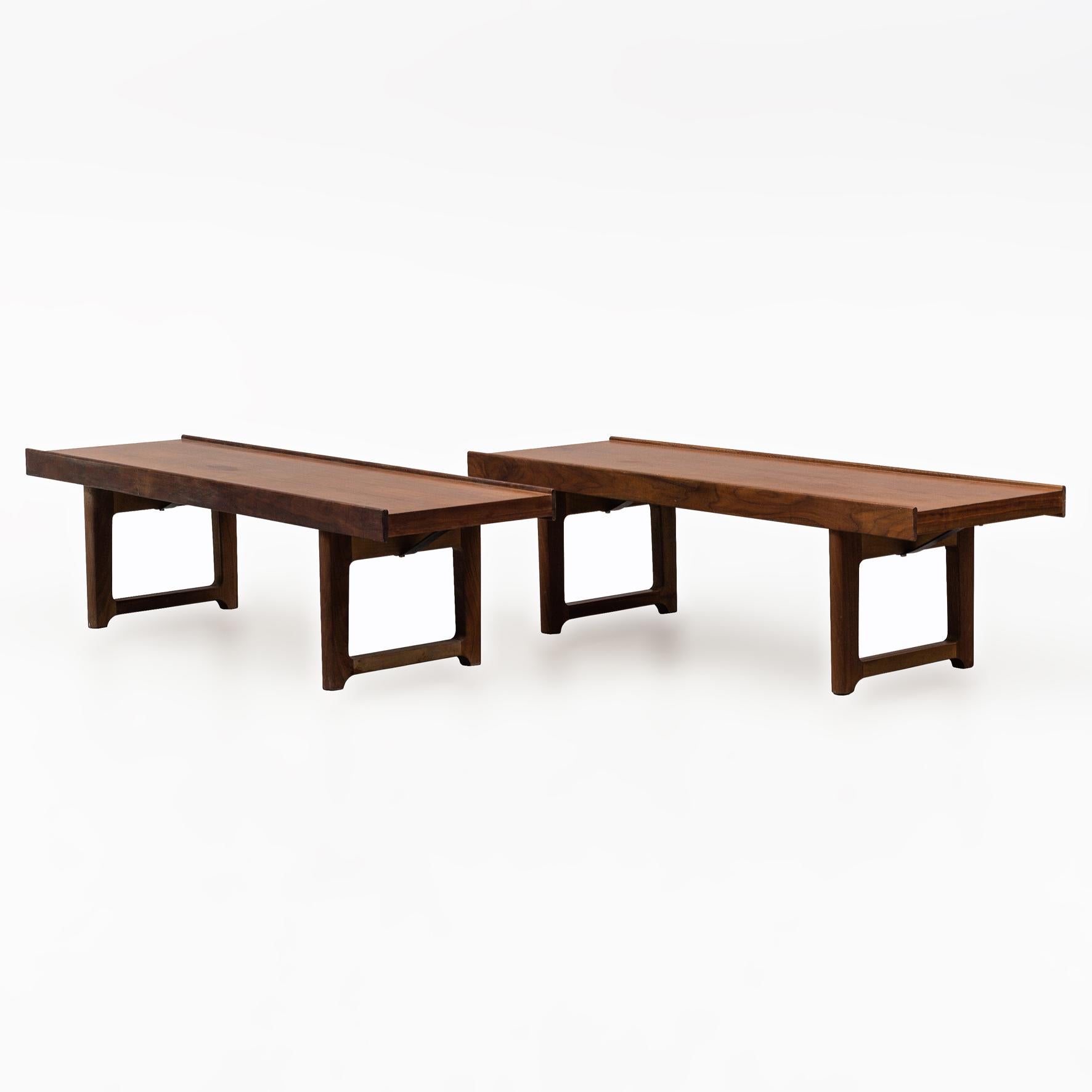 A pair of rectangular teak side tables/benches.
Each table on two pairs of feet joined by a stretcher.
Manufactured by Bruksbo.
With a label by the producer,
Norway,
1960s.
 