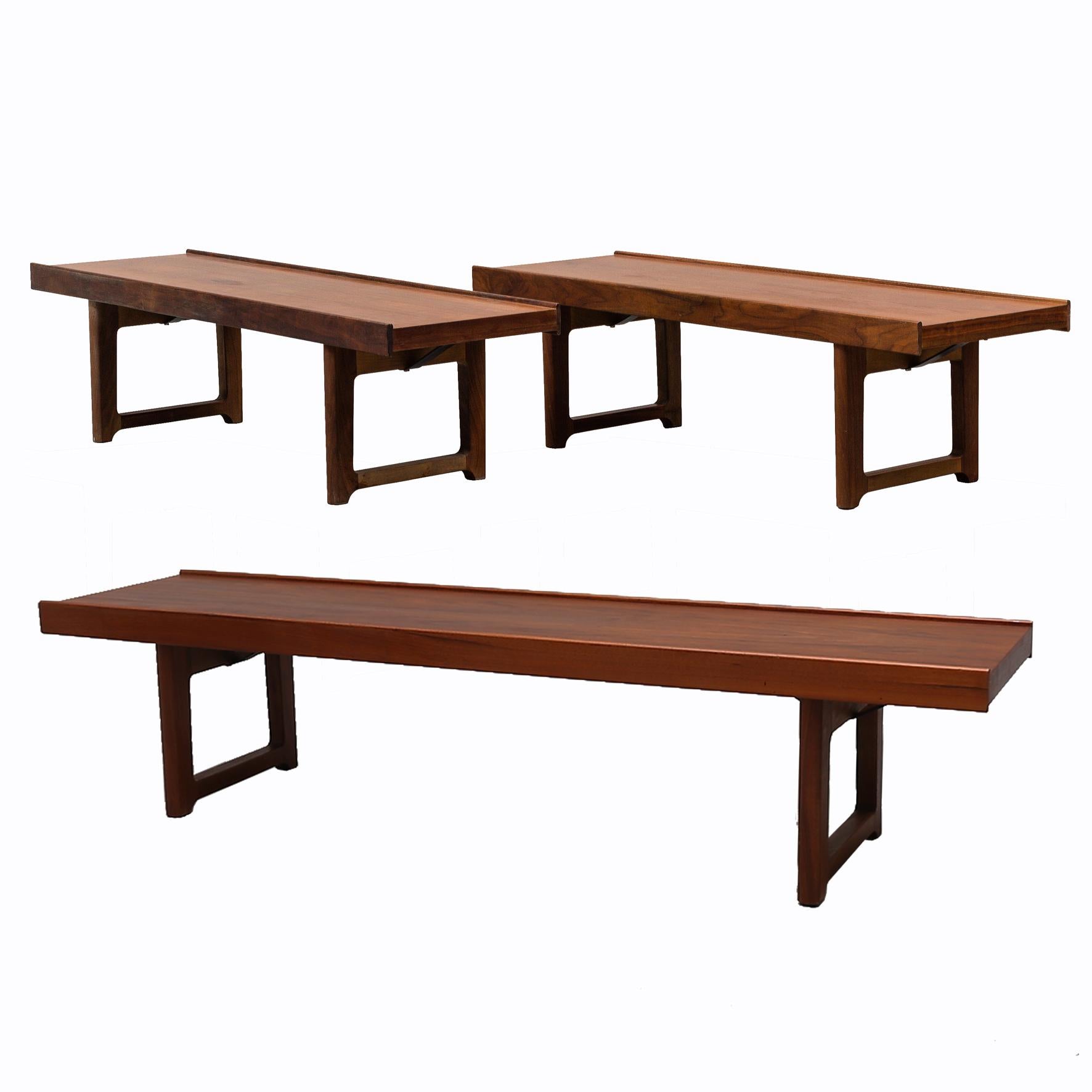 A suite of three rectangular teak side tables/benches.
Each table on two pairs of feet joined by a stretcher.
Manufactured by Bruksbo.
With a label by the producer.
Norway.
1960s.

These pieces can be used weather as tables or benches.

Two
