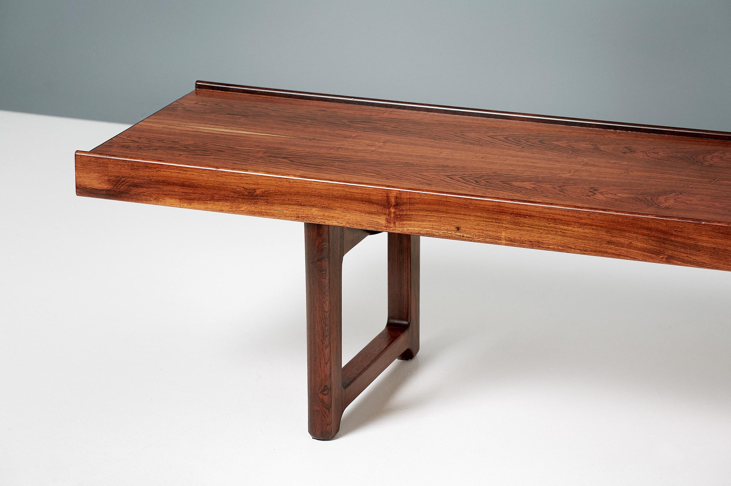 Torbjørn Afdal

Iconic midcentury design from Norway. Torbjorn Afdal's Krobo bench, circa 1960 was designed as a multipurpose bench for producer Bruksbo and can also be used as a low coffee table. This example comes in exquisite rosewood and has