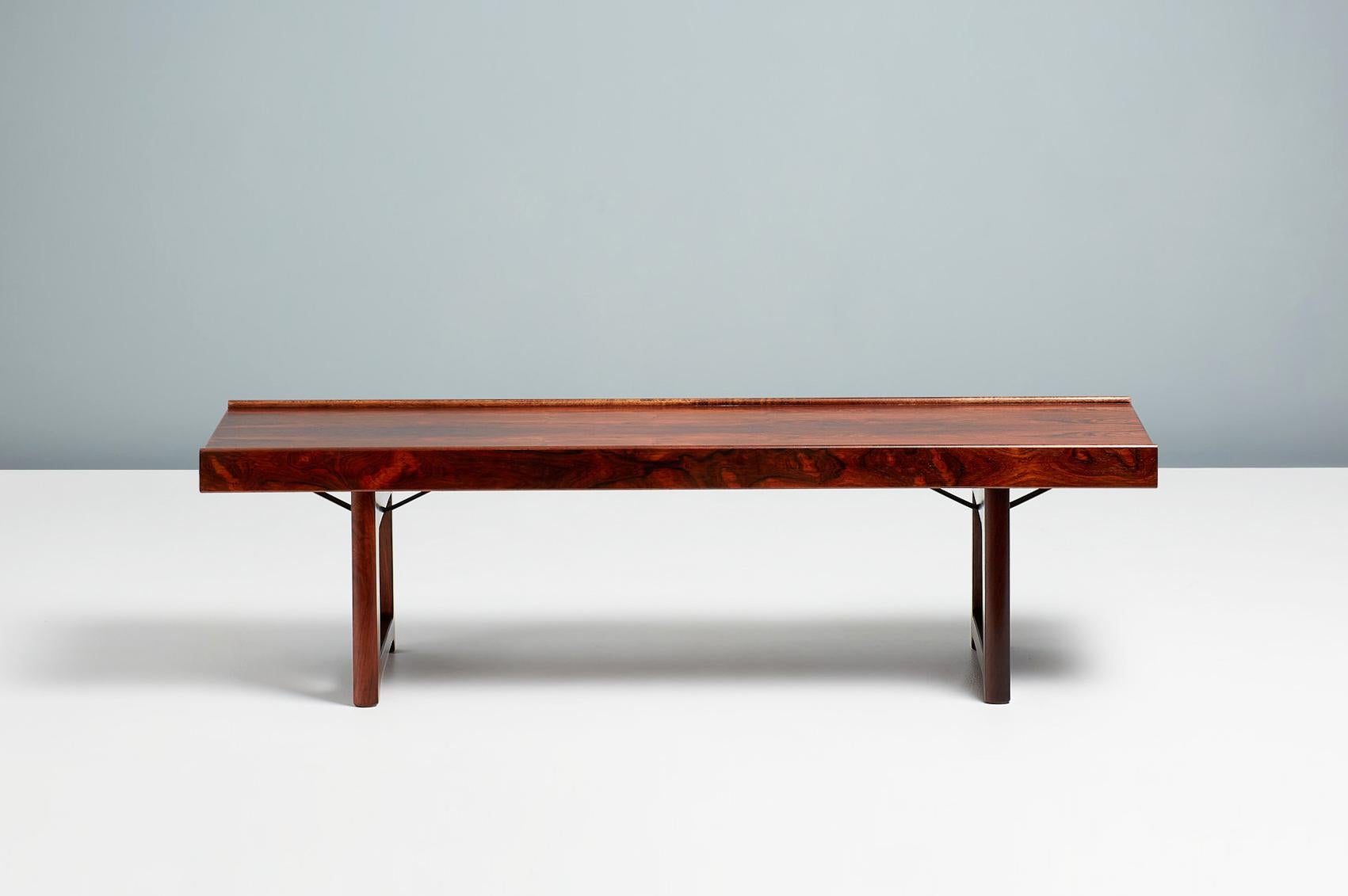 Torbjørn Afdal

Iconic midcentury design from Norway. Torbjorn Afdal's Krobo bench, circa 1960 was designed as a multipurpose bench for producer Bruksbo and can also be used as a low coffee table. This example comes in exquisite rosewood and has