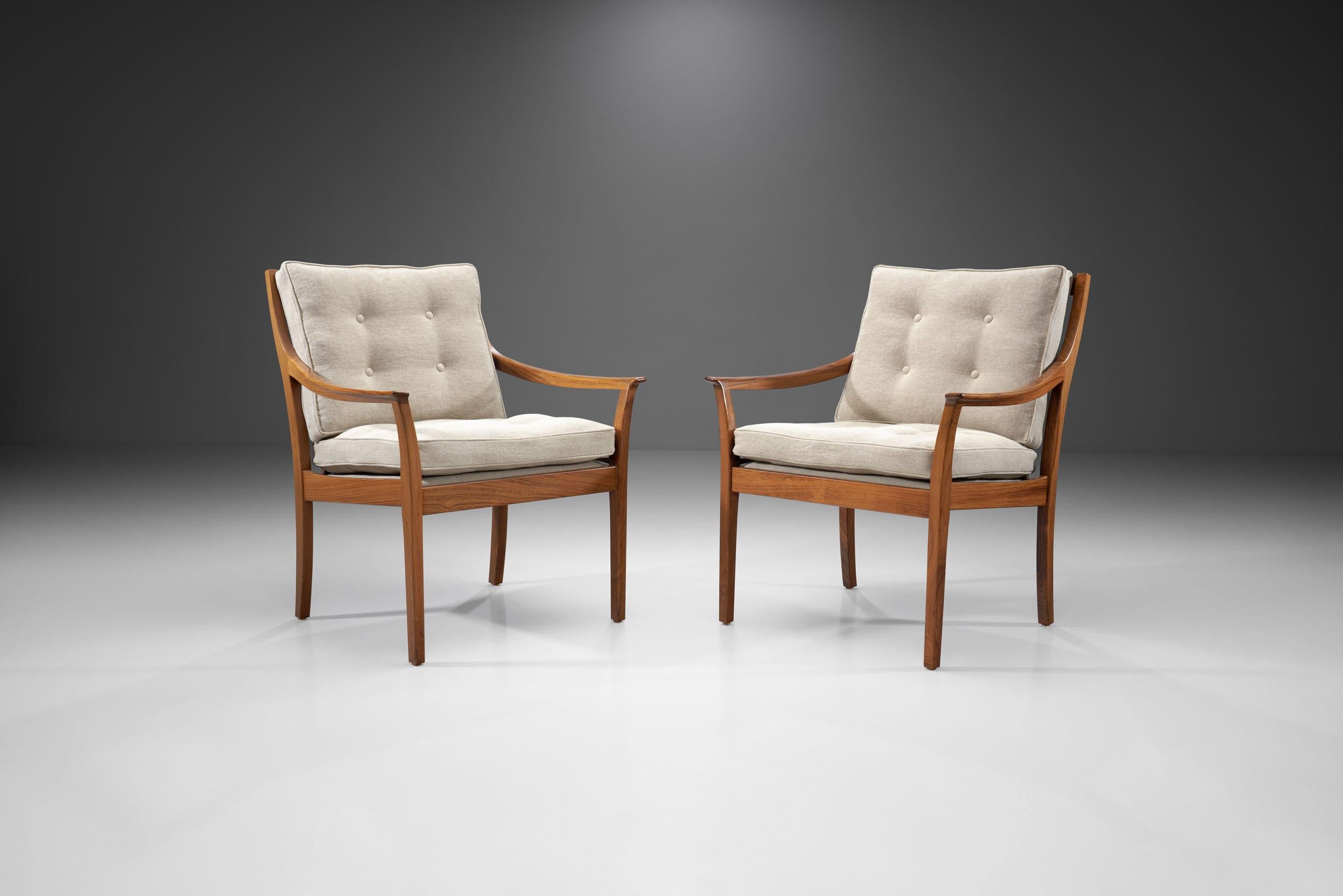 This rare pair of wood “Vinett” armchairs was created by Jackie Kennedy’s favorite Norwegian designer, Torbjørn Afdal. His Norwegian designs impressed not only the former First Lady, but the Japanese Emperor and the Prime Minister Gro Harlem