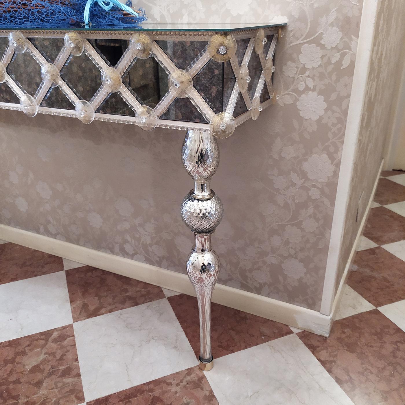 A sublime showcase of craftsmanship by expert artisans of the Venetian glassmaking tradition, this exceptional console will make a uniquely lavish accent in a refined entryway. Distinguished by meticulously applied details, it features a mirror top,