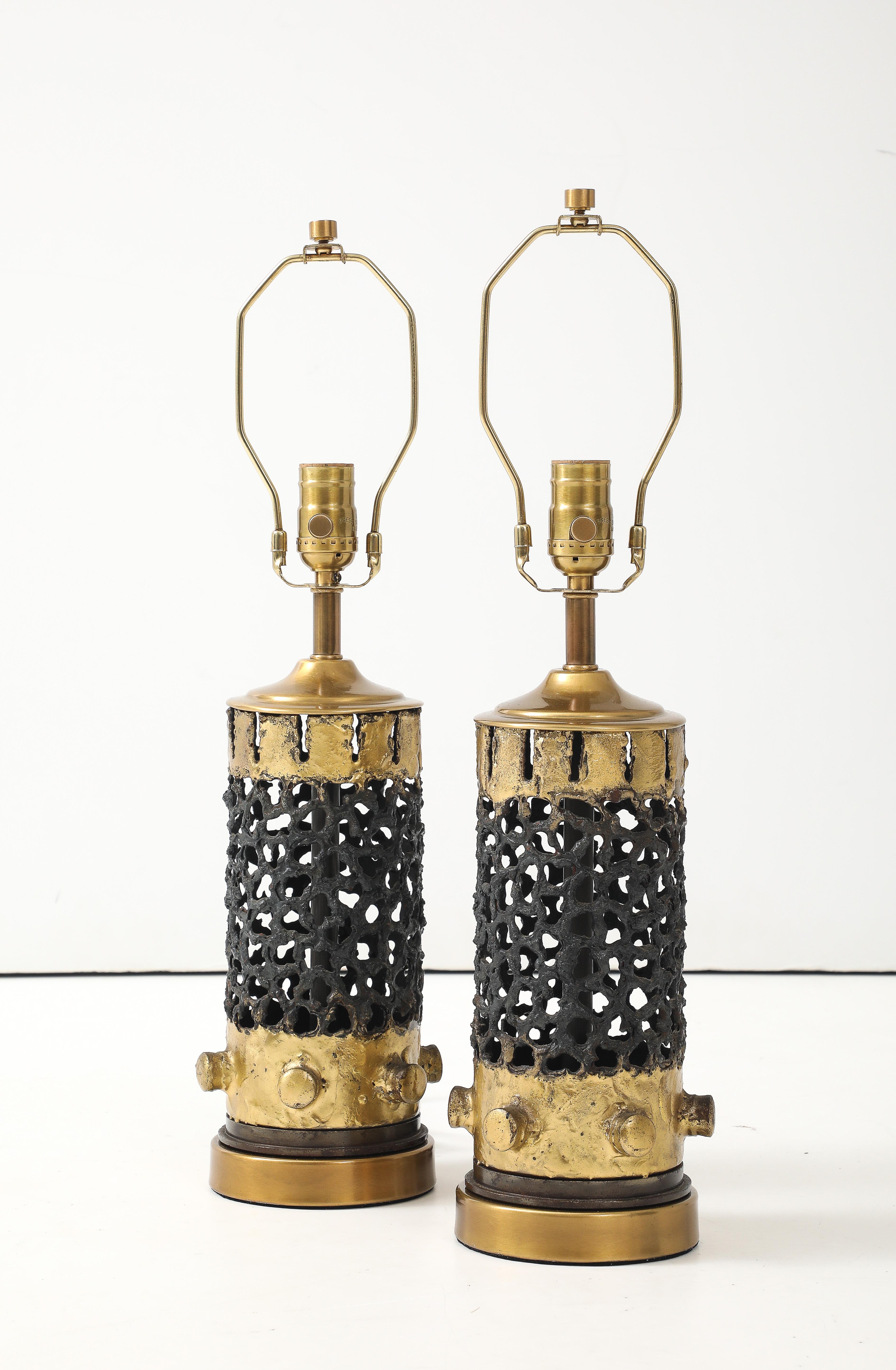 Pair of torch cut Brutalist metal lamps with gilded accents. Lamps have been professionally rewired with black twist cord.