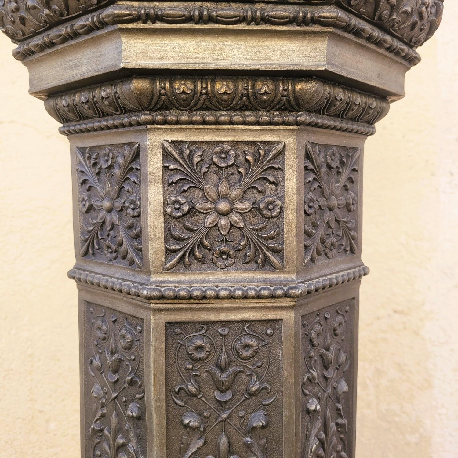 Large torchiere in spelter representing a woman in a draped dress, carrying a lantern at arm's length: very beautiful glass globe decorated with flowers  

She is standing on a very beautiful column entirely decorated with flowers and lion heads  