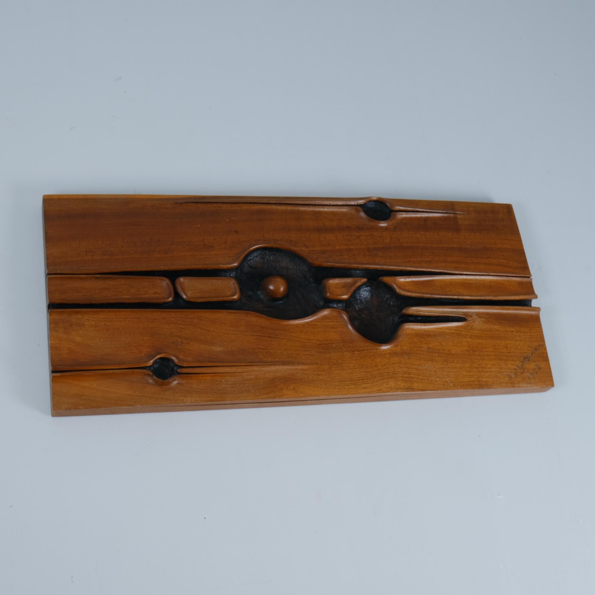 Not much is known about the artist, except that this is a commissioned piece for a personal friend of the sculptor. This impressive block of solid teak wood has been carved beautifully, giving it an abstract look, and torched afterward to give it