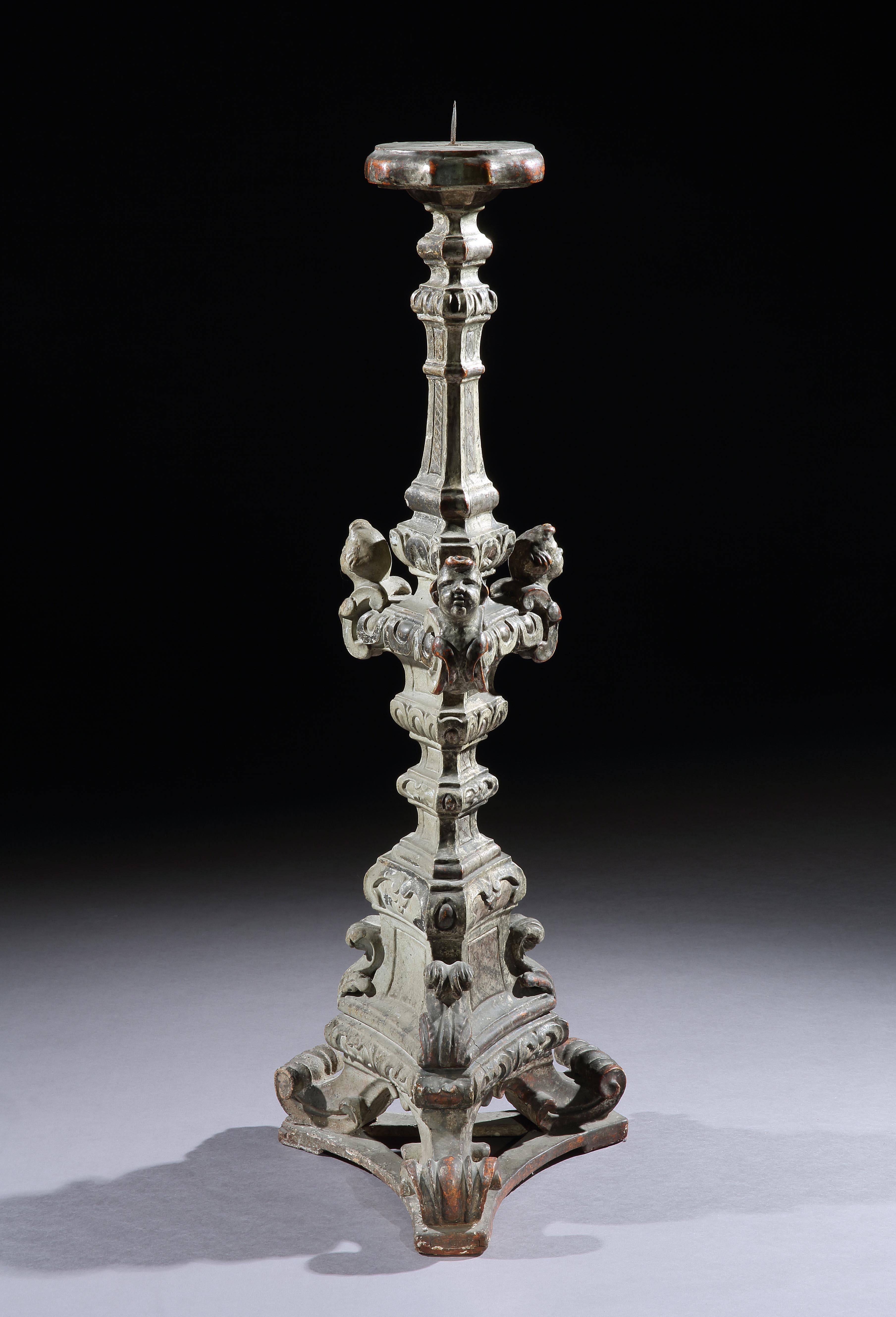 This massive torchere is characteristic of the baroque period in both the form and ornament employed. It would have glistened with the light reflecting from the matt and burnished silvered surfaces. It is an impressive piece injecting gravitas into