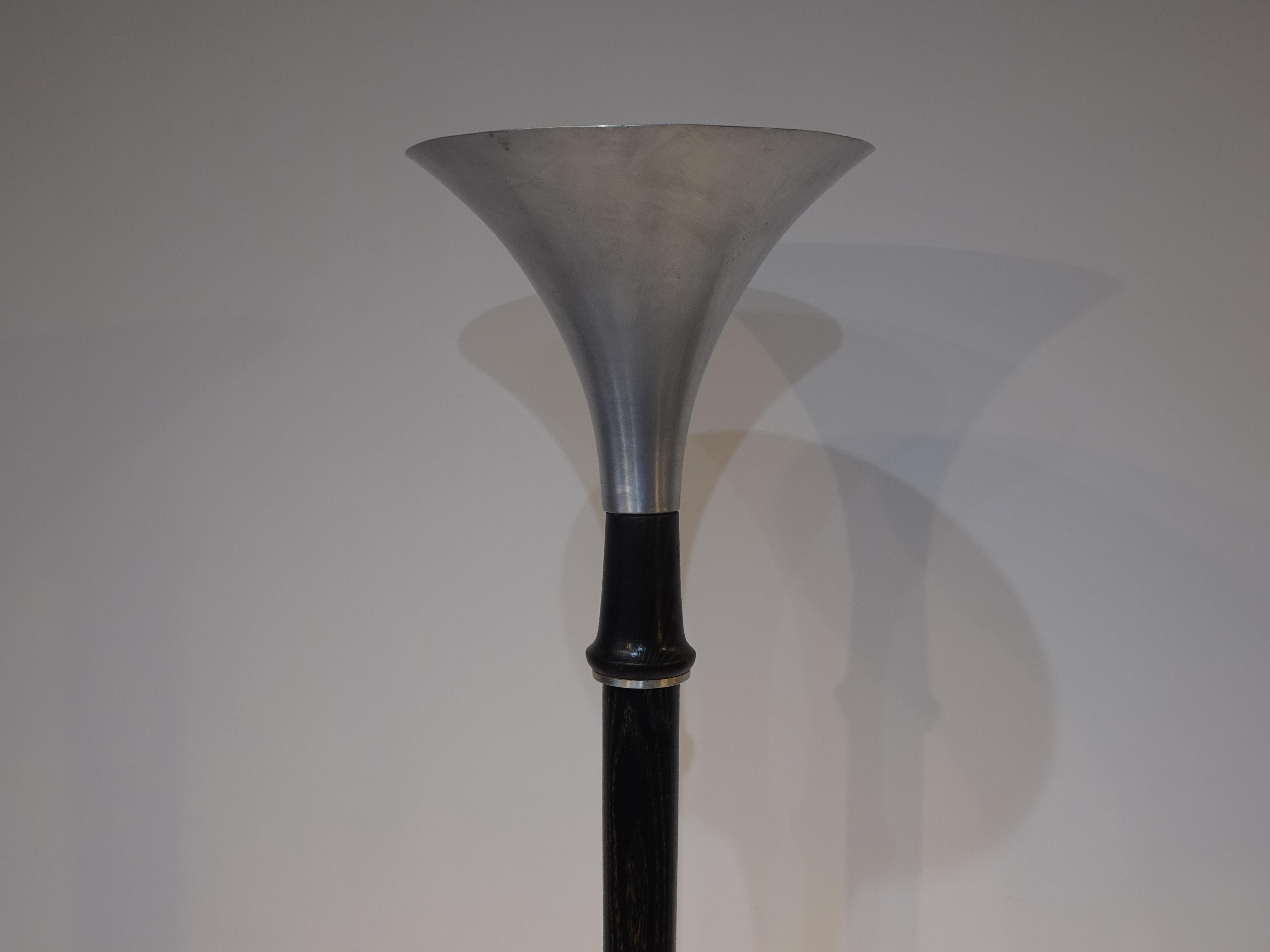 A very well crafted torchiere floor lamp with spun aluminum shade and base with aluminum detail to the dark pickled wood shaft. Attributed to Russel Wright and manufactured in the 1940's a piece that works with Art Deco, Machine Age or Mid Century