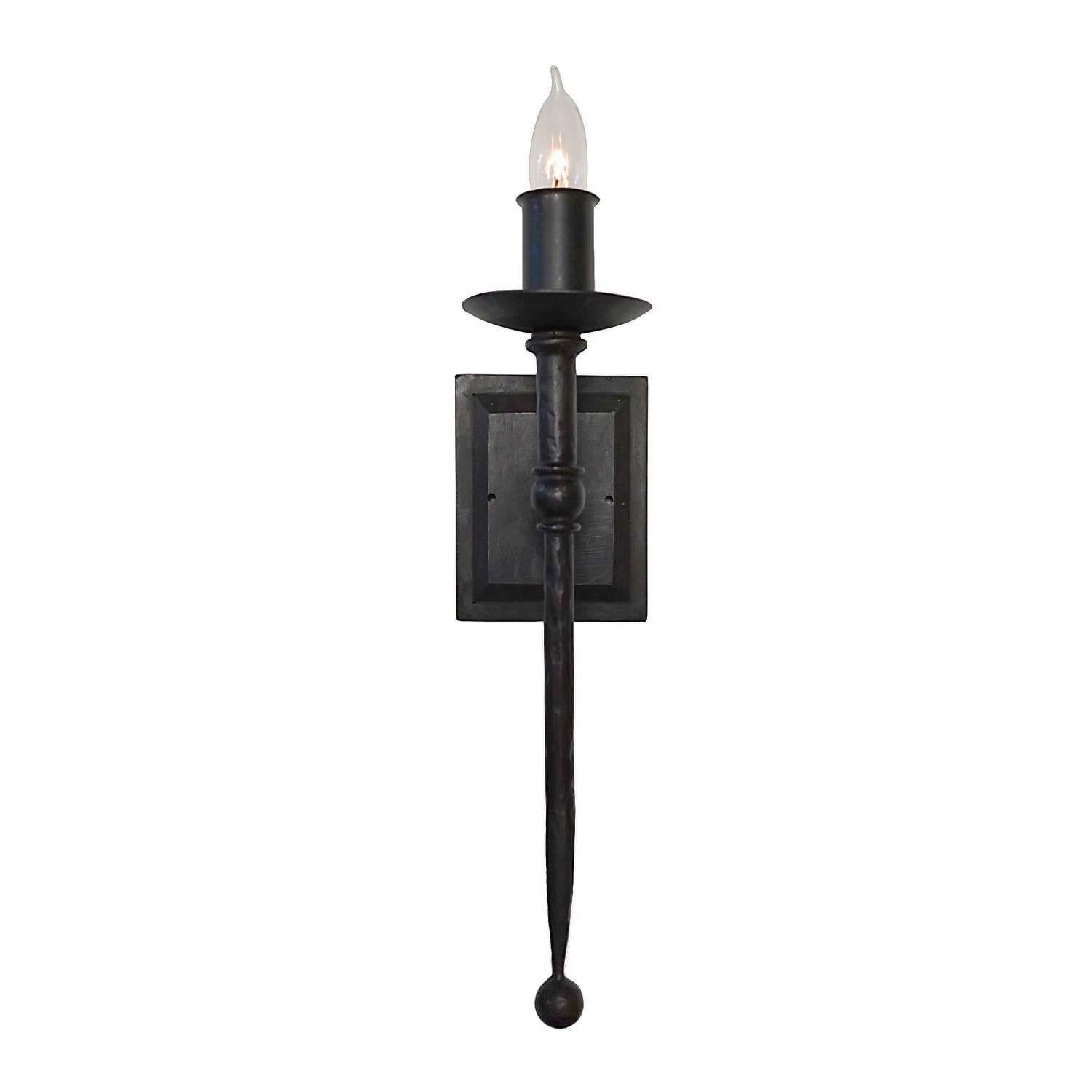Elegant wall sconce with gentle tapering, clean lines, classic torcheire details and a curved c detail for additional style & character. Hammered texturing and a rich waxed finish gives this wrought iron fixture a softer look. At home in a classic