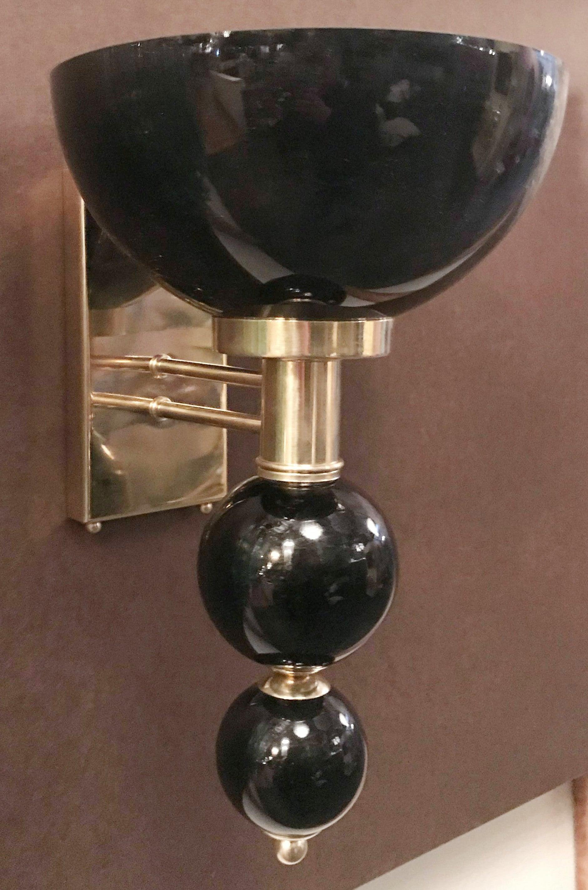 Italian wall light with hand blown black Murano glass, mounted on polished brass metal finish frame / Designed by Fabio Bergomi for Fabio Ltd / Made in Italy.
1 light / E26 or E27 type / max 40W 
Measures: Height 16 inches, width 10 inches, depth 11