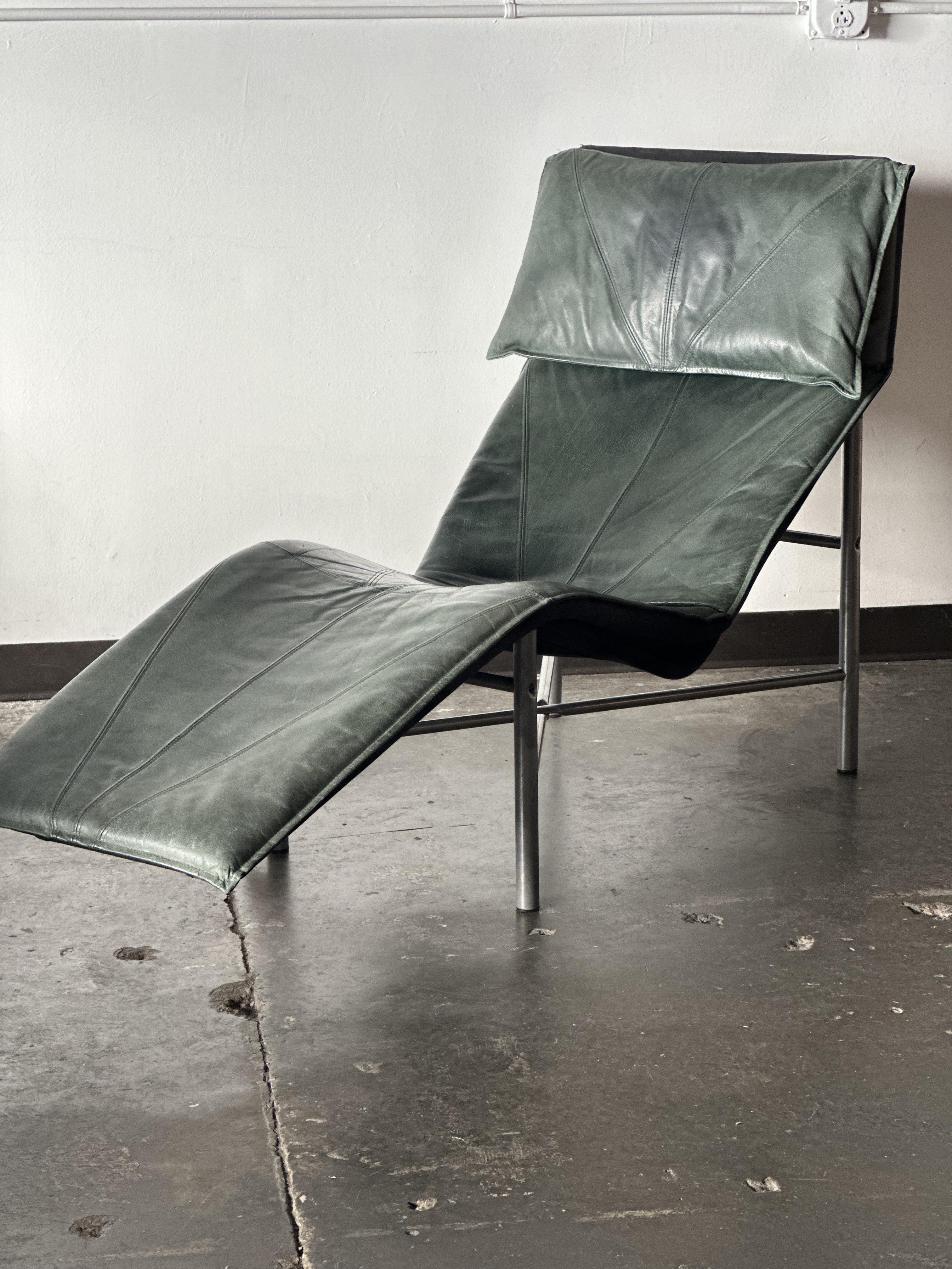 Skye Lounge by Tord Bjorklund for Ikea as documented in the Ikea 1990 catalog. Features a dark green leather cushion situated on a black canvas sling affixed to a silver metal tubular frame. Leather has slight patina from previous life. 

Lounge