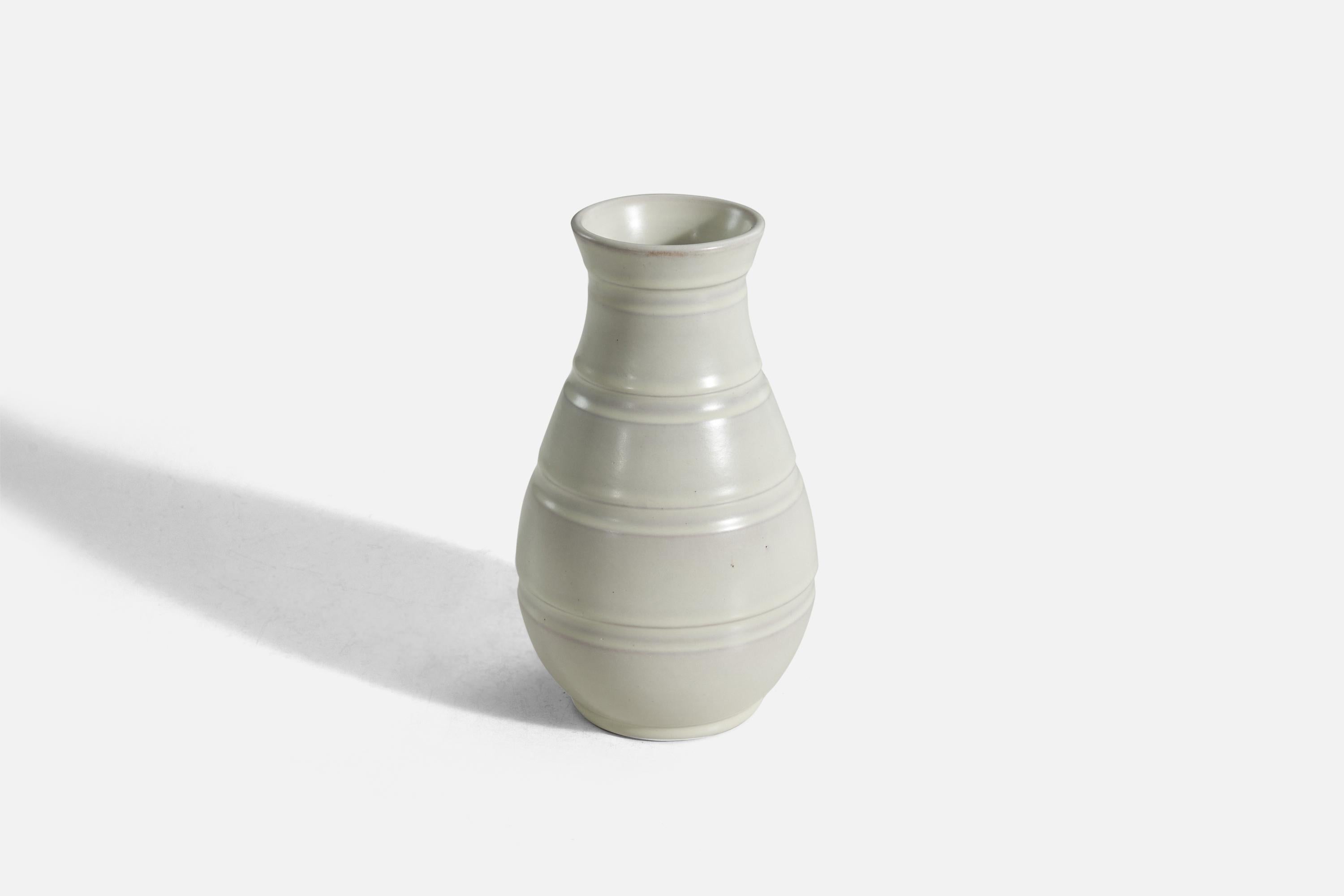 A white, glazed earthenware vase designed and produced by Töreboda Keramik, Sweden, c. 1940s.
 