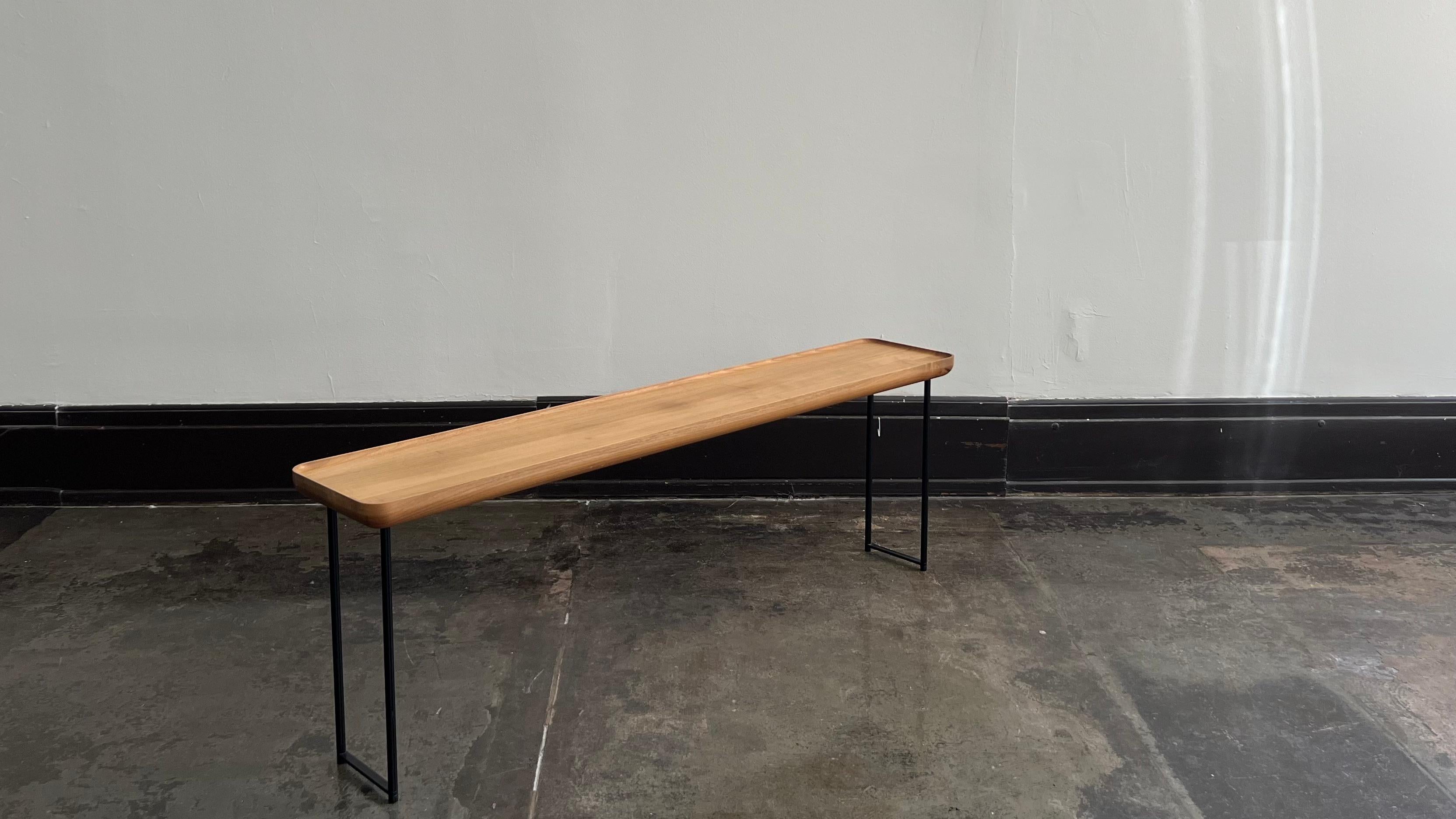 Influenced by Japanese principles, the Torei table collection was created as a group of multi-functional low tables. With surface options such as walnut and Carrara marble, the Torei collection focuses on natural materials to pair with the steel