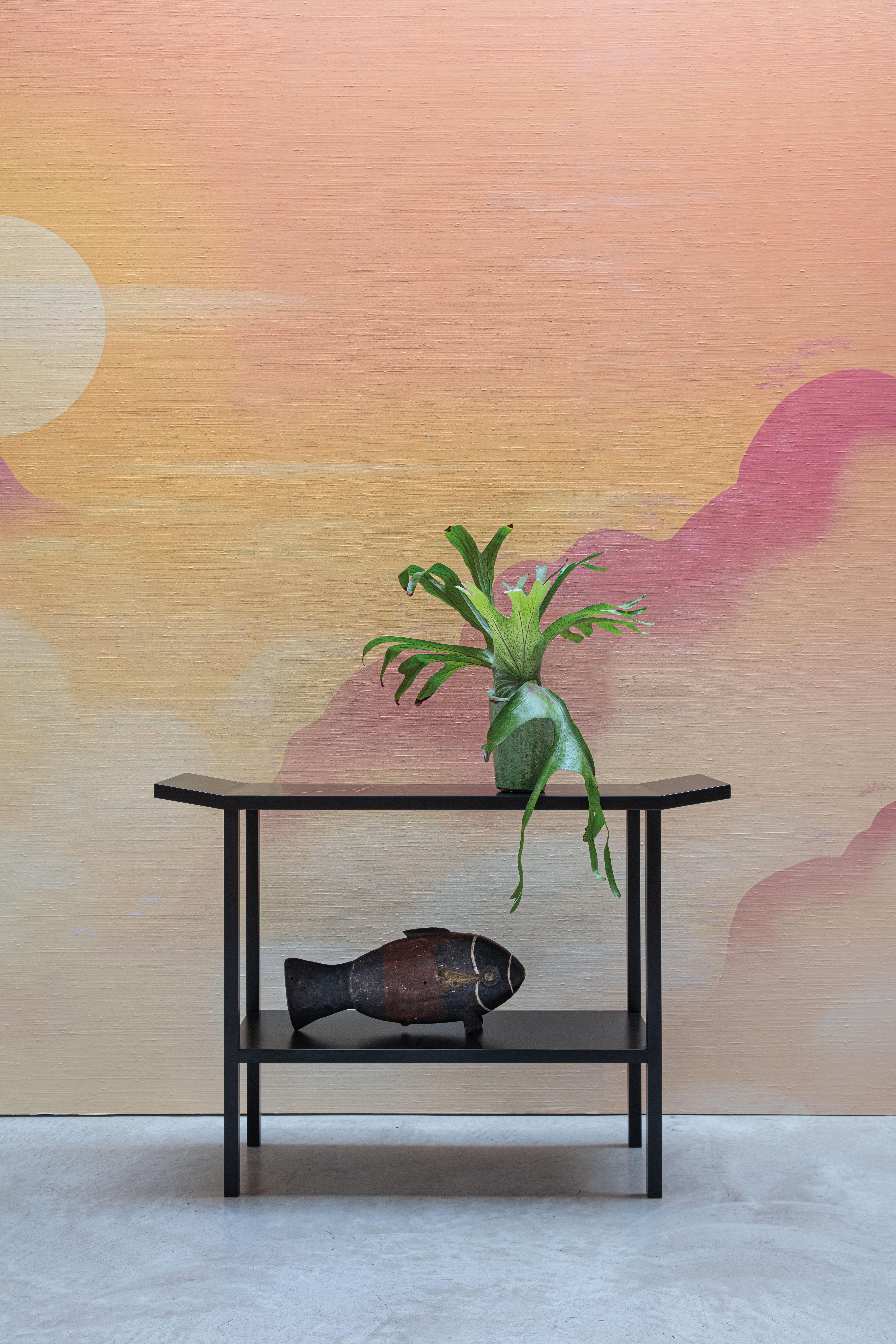Defined by its sleek silhouette, this console table is an exceptional expression of minimalist elegance. Entirely crafted from wood fibre, it is hand-lacquered with a satin and semi-matte finish. Featuring slightly raised ends, the rectangular top