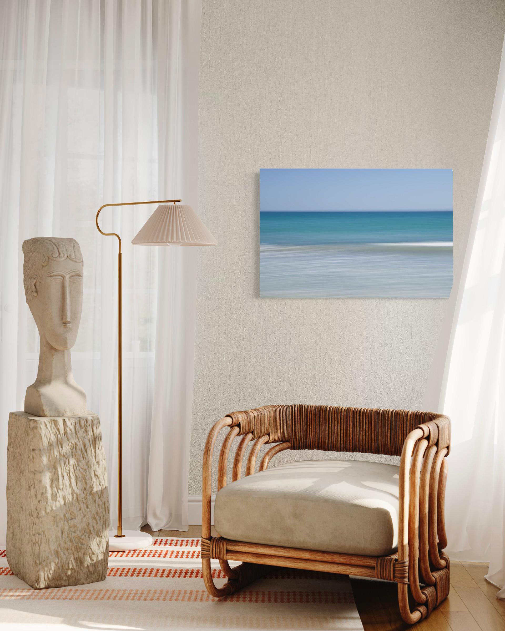 This photograph by Tori Gagne features an abstracted seascape composition and a coastal blue, turquoise, and white palette. An edition size of 50, this photograph by Tori Gagne is available as a metal sublimation print with a 1.3” deep silver flush