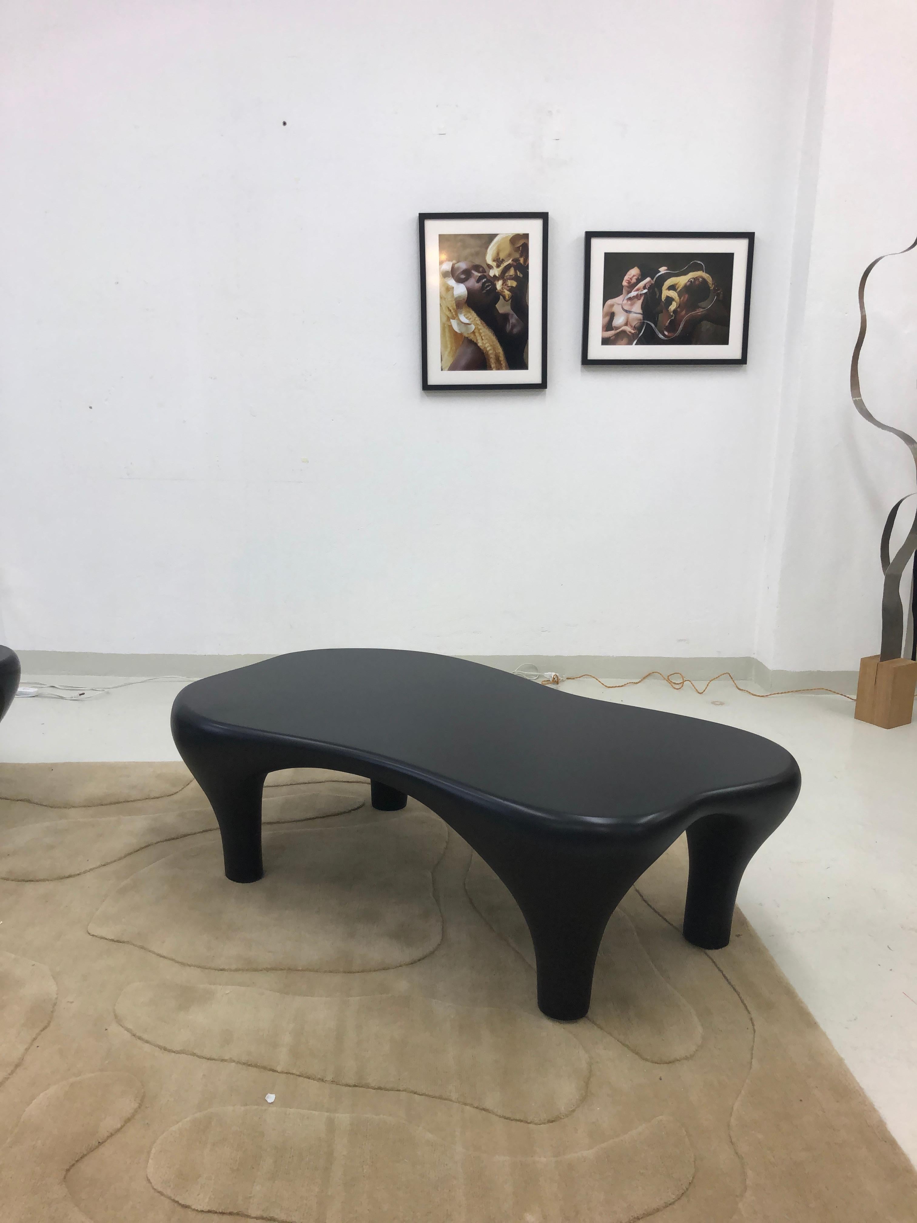 Sculptural coffee table finished with matte lacquer.
Sculpted by hand this anthropomorphic form feels alive and surprises the eye from all angles.