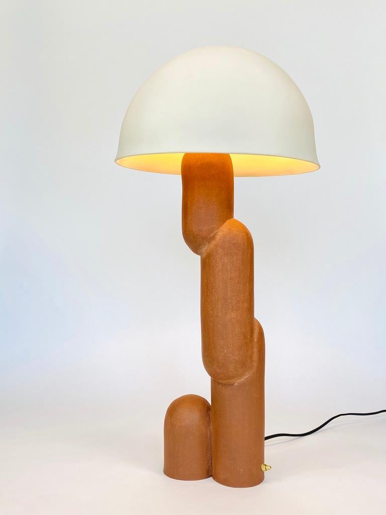 Handmade ceramic lamp. Raw basaltic stoneware, 3mm thin translucent, hand cast and polished porcelain lampshade.
 