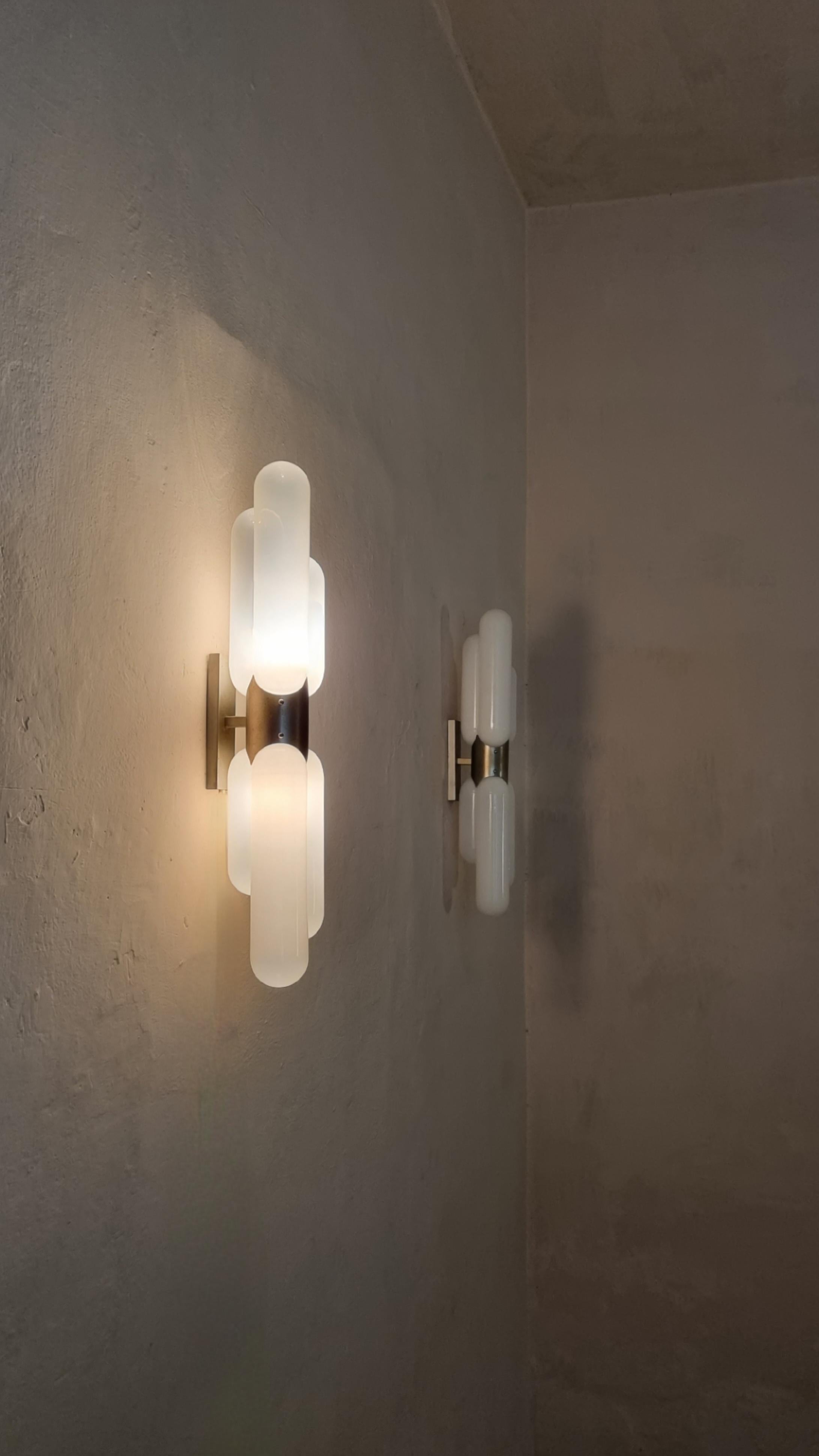 Large wall sconces designed by Carlo Nason for Mazzega, Italy 1960s.
Brushed metal structure, opal glass diffuser.
Excellent condition.

Mazzega’s origins date back to 1946 in Murano, the island of glass tradition, where the company still produces