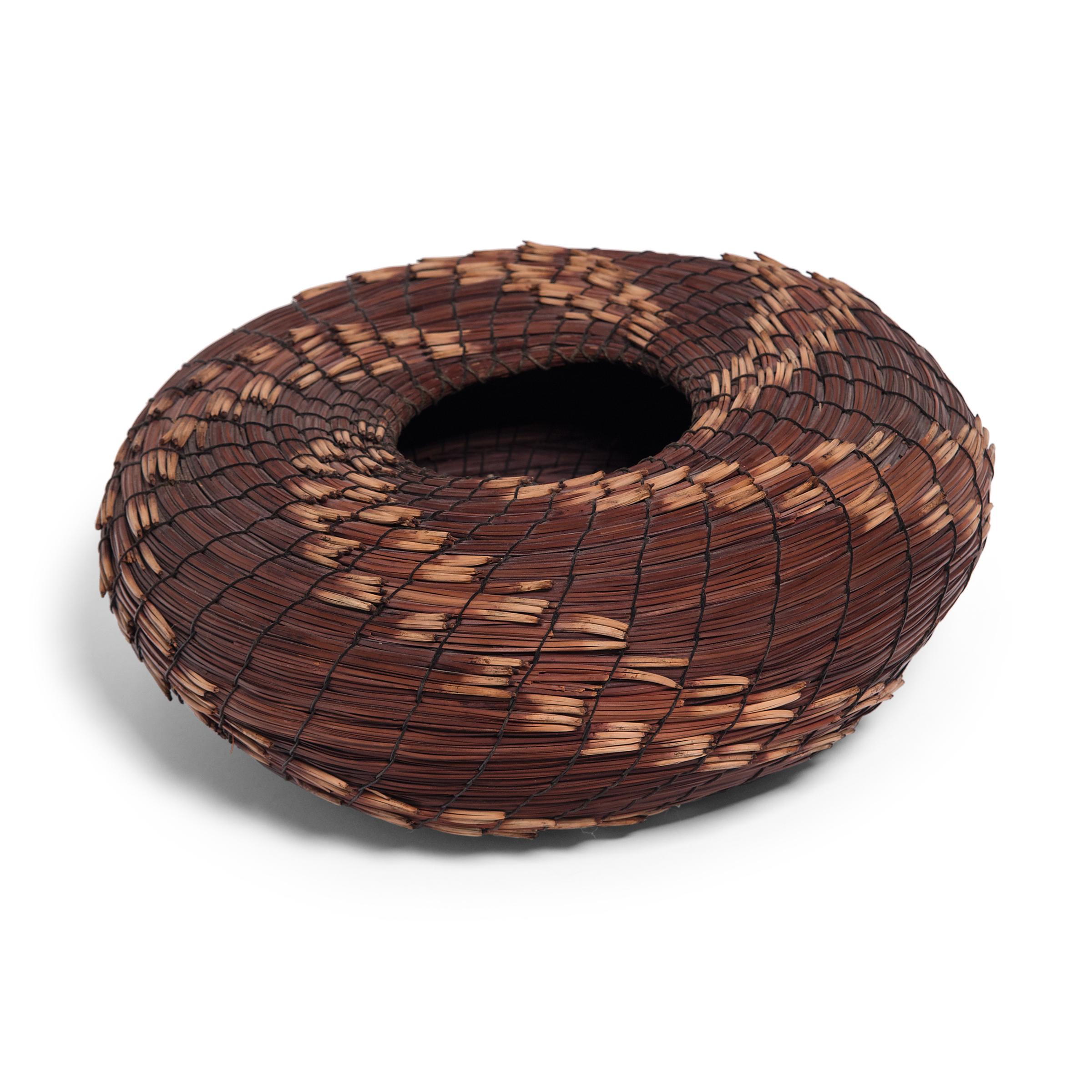 A fantastic example of contemporary folk art, this spiral-form basket is attributed to American artists Fran and Neil Prince, who created sculptural works throughout the late 20th century and specialized in working with fallen Torrey Pine needles.