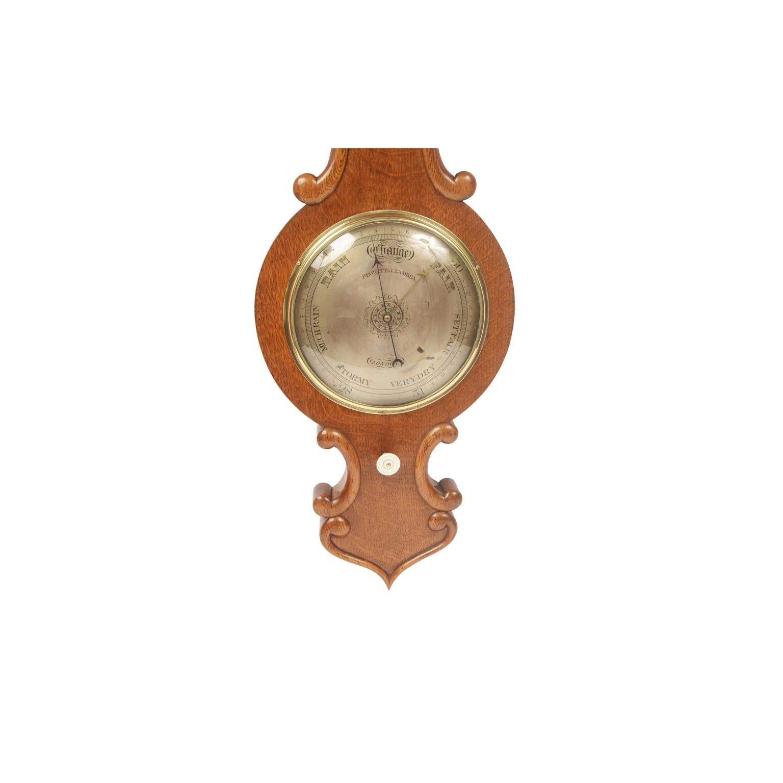 Torricellian barometer of oak wood, signed Negretti & Zambra London from the second half of the 19th century, complete with reading vernier for checking the pressure variation and thermometer. 
Height 98 cm - 10.6 inches, width 27 cm - 38.5 inches,