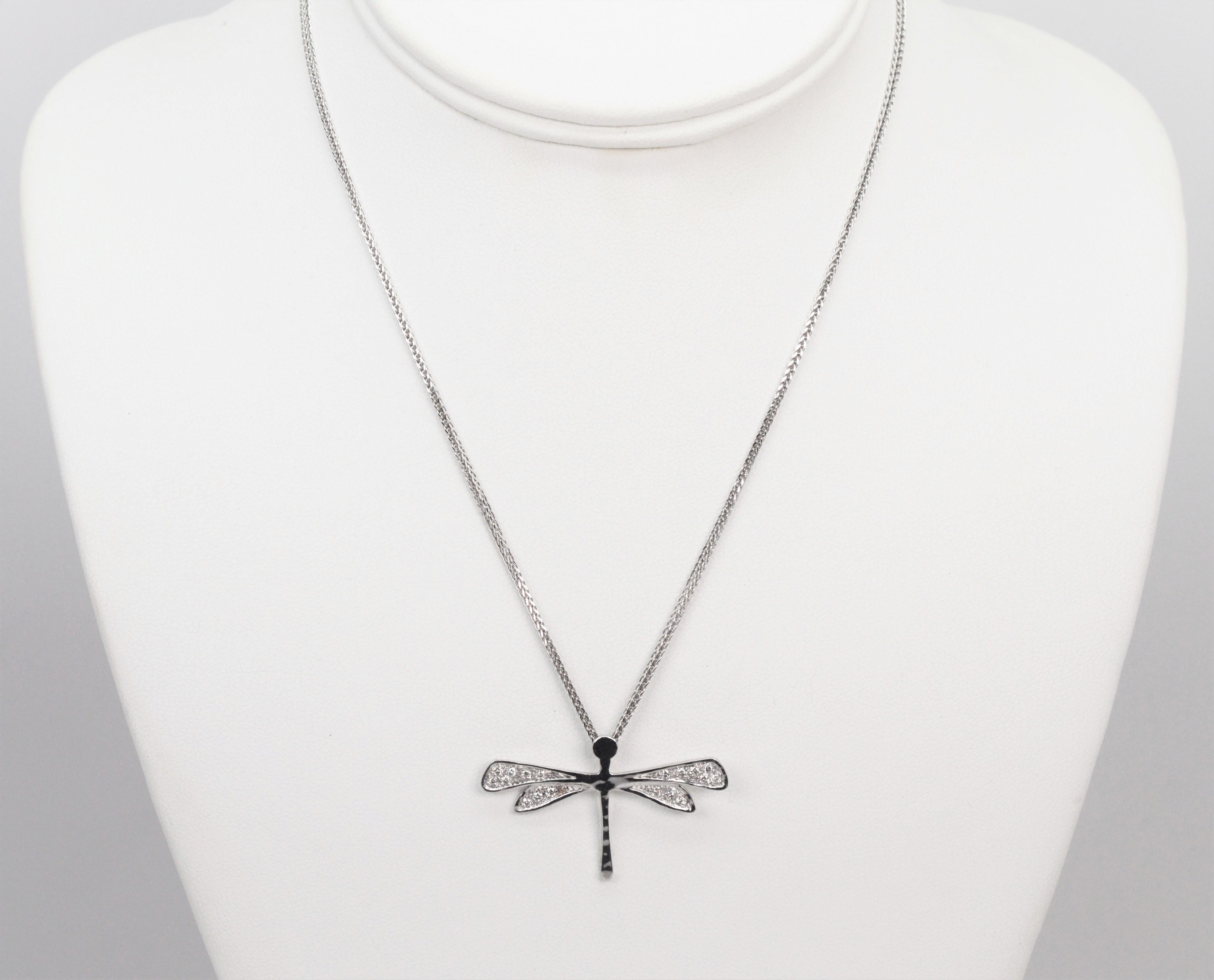 From Torrini's 1369 Renaissance Collection, pave diamonds sparkle on the wings of this adorable pendant necklace of fourteen karat 14k white gold. With a hand hammered finish, and 1.5 inch wing span, the pendant delicately floats on a 16 inch white