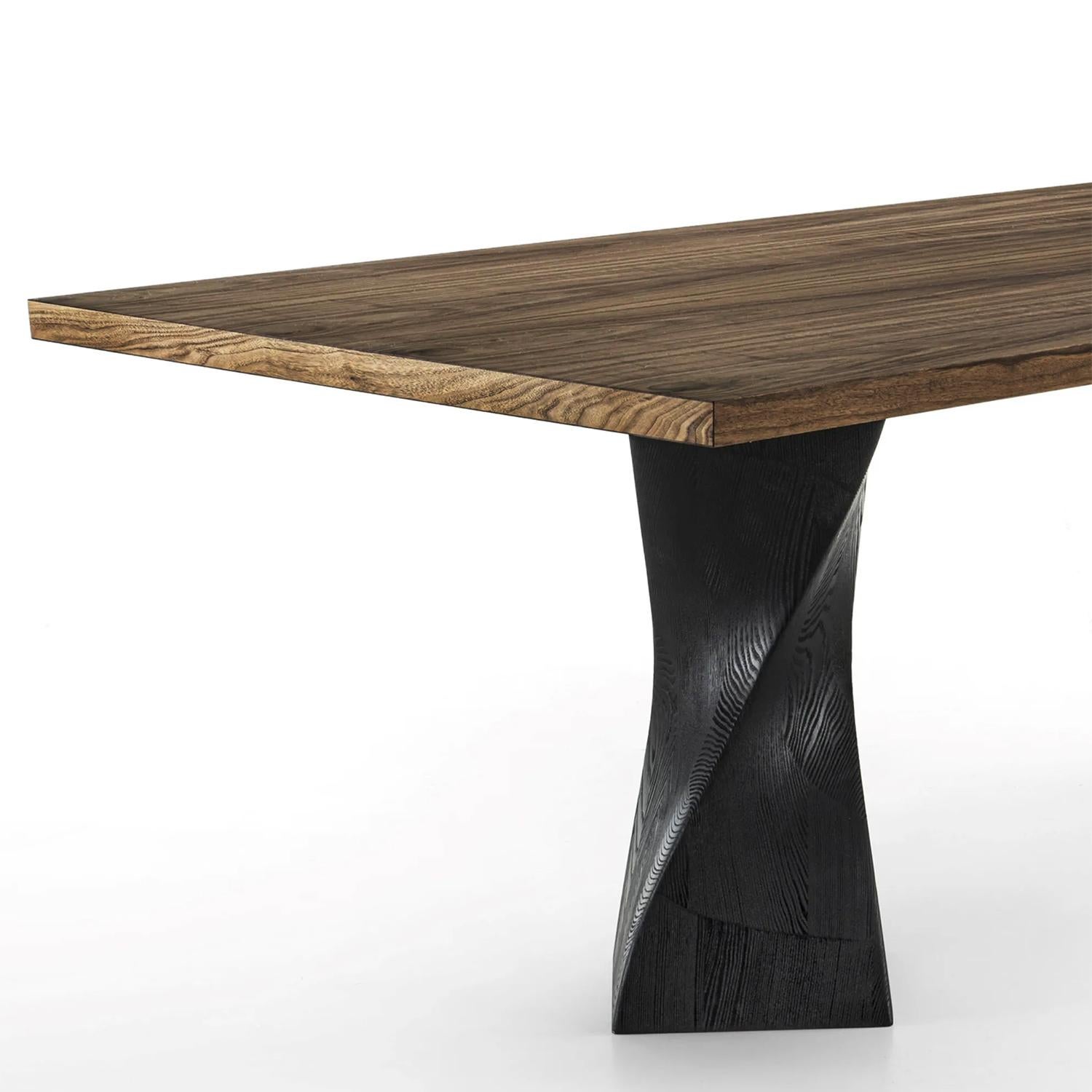 Table de salle à manger Torsade Noyer avec plateau en 
Placage de panneaux de particules en noyer avec bords biseautés. 
Avec 2 pieds en frêne massif en finition pigmentée noire.
Également disponible en :
L220xD100xH75cm, prix :