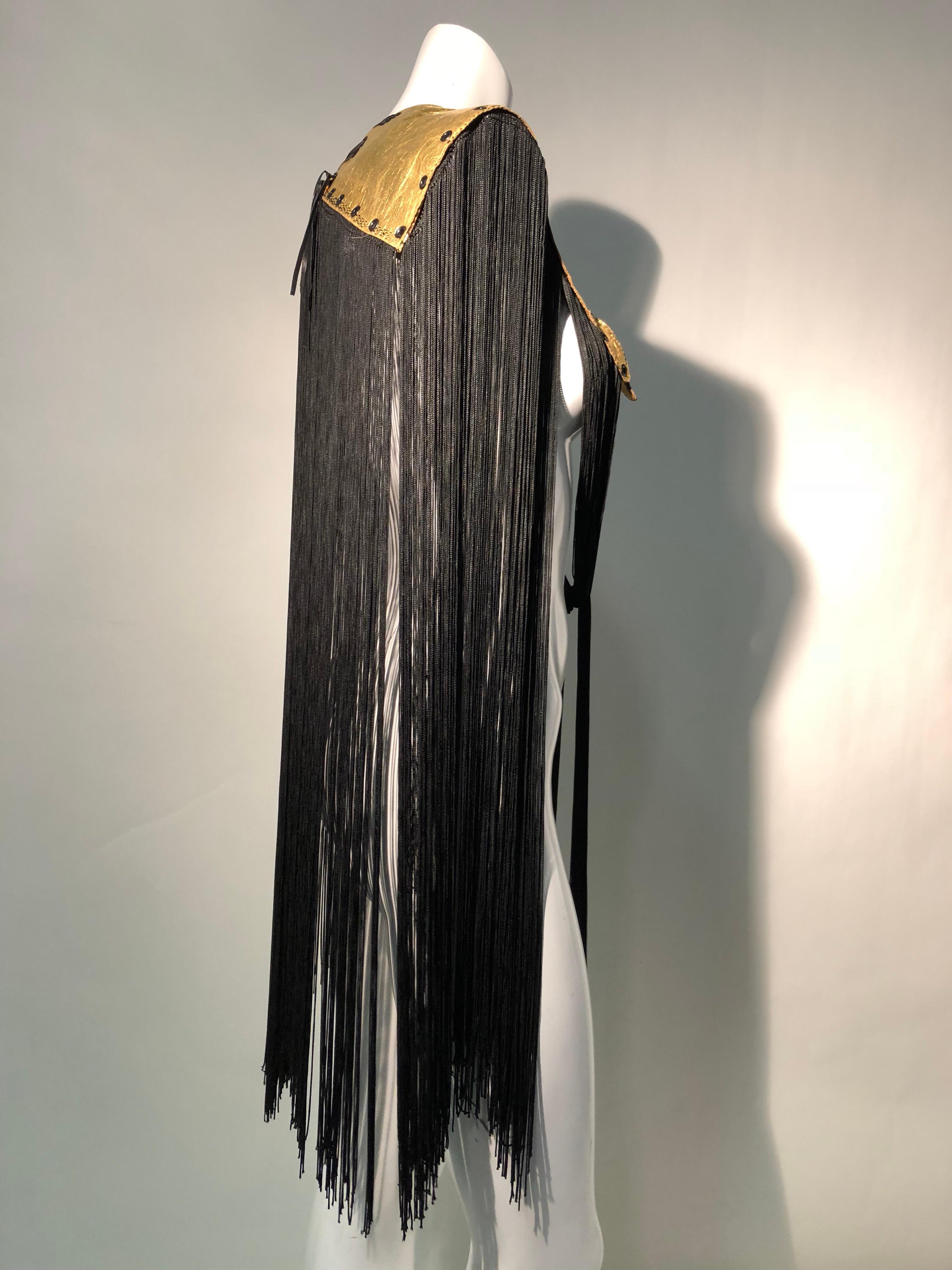A unique Torso Creations shawl fashioned from 1940s gold foil covered leather gloves, 1940s vintage long rayon fringe and metal eyelets. Gold leather gloves lay across each shoulder and lace up at the back of the neck. Truly one-of-a-kind!