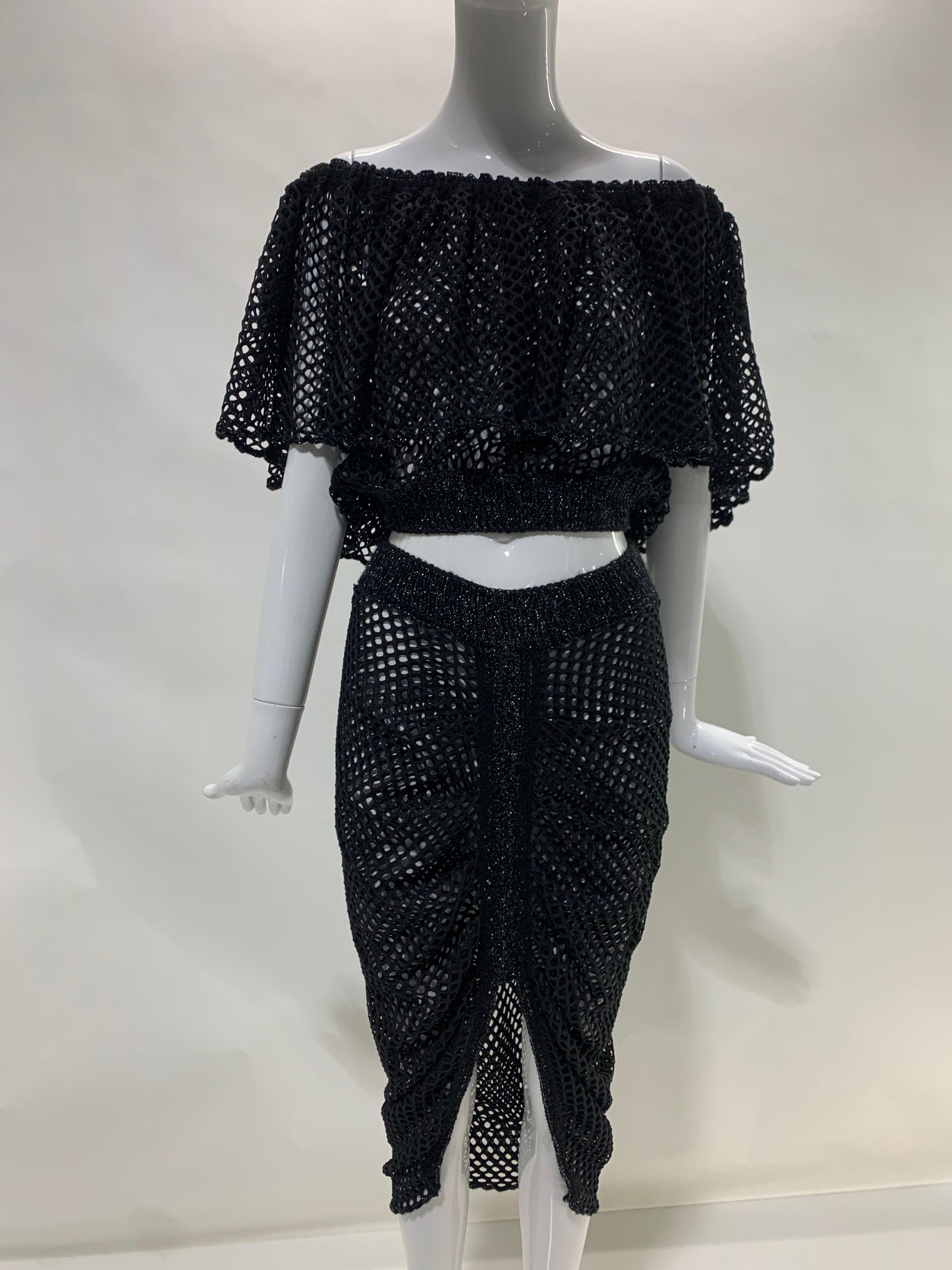 Torso Creations 2-Piece black fishnet ensemble: Off-the-shoulder blouse with gathered elasticized neckline and trimmed with black metallic lurex knit. Skirt is ruched down center front and has a rib-knit waistband is trimmed in black metallic lurex