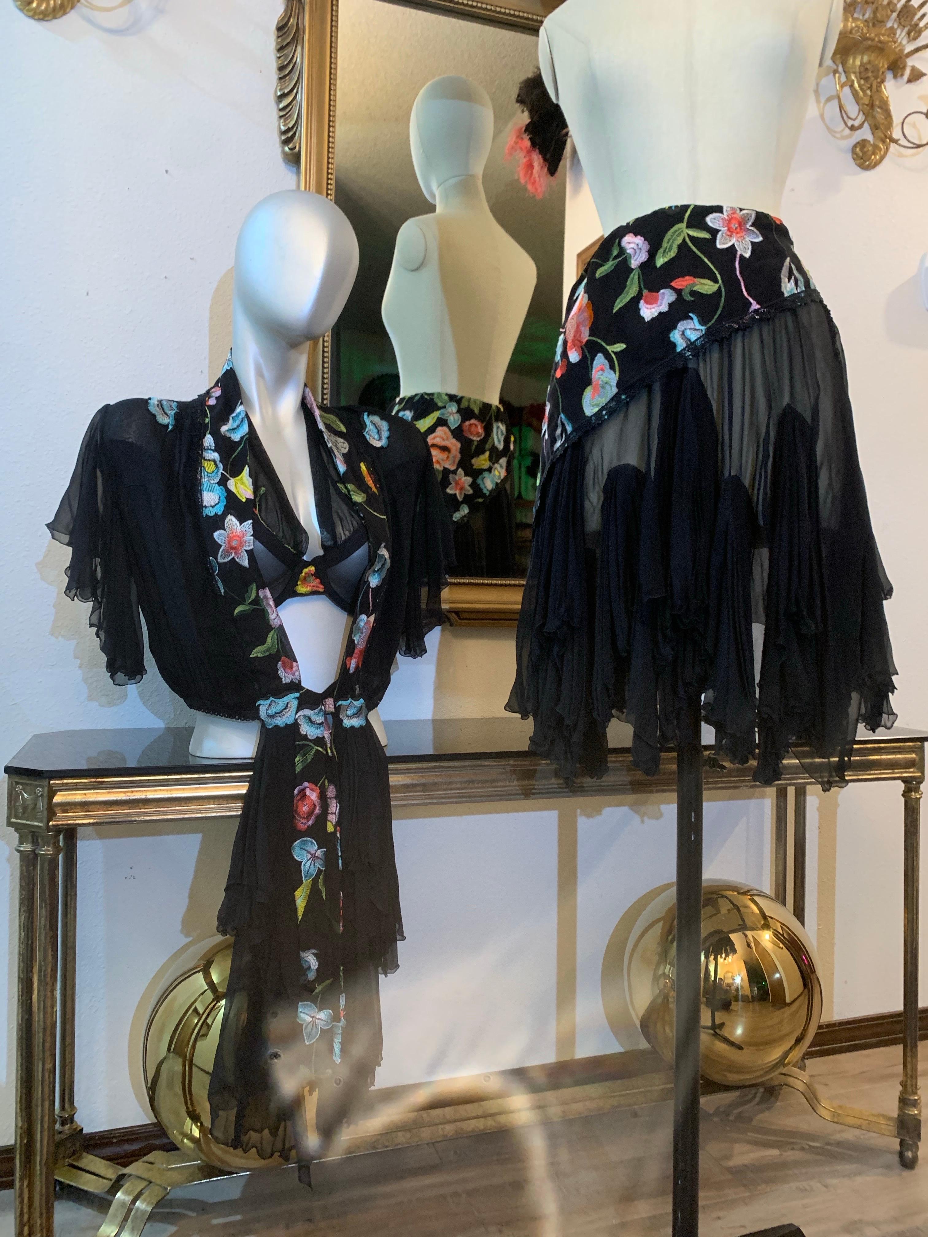 Art-To-Wear Torso Creations 3-piece ensemble in black silk and multicolor floral embroidered mesh consists of a sheer mesh halter bra top with applied floral embroidered pieces, a silk chiffon bolero-length jacket with floral embroidered trim,