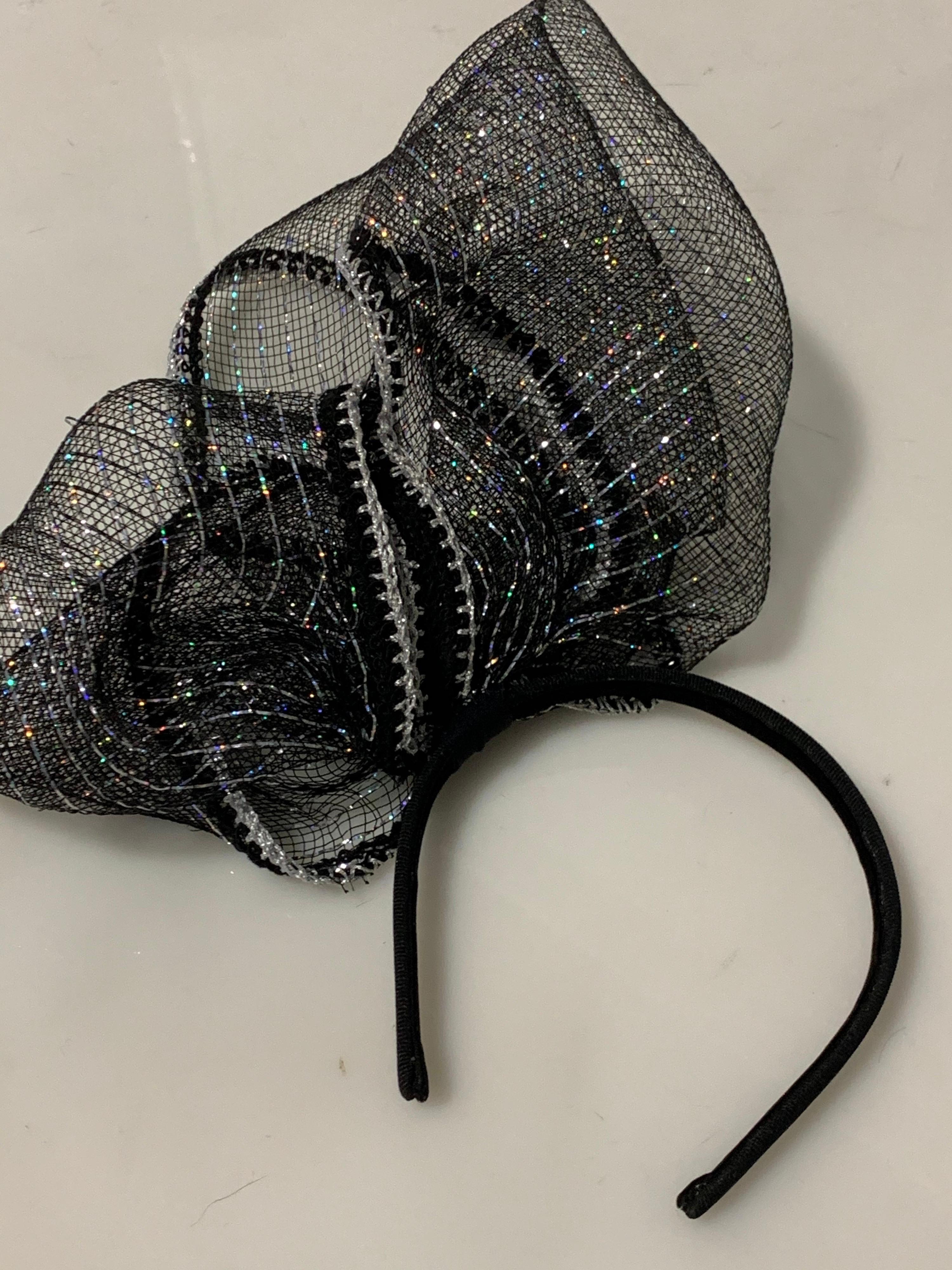 Contemporary Torso Creations dramatically sculpted black and silver horsehair and lurex bow fascinator headband. One size fits all.