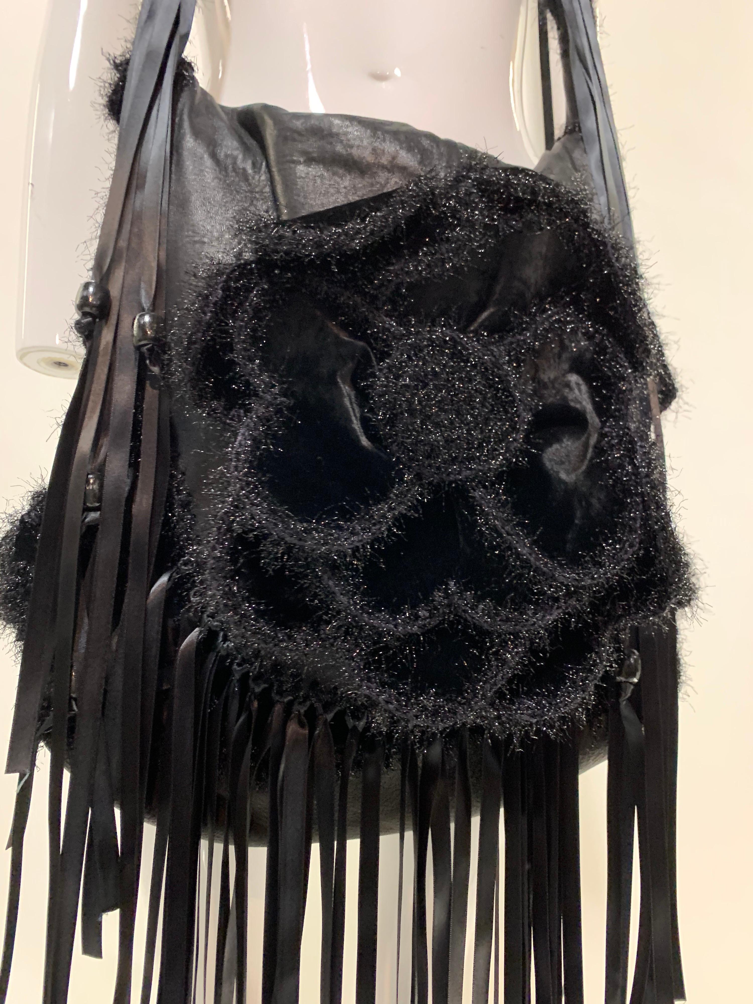 A fabulous Torso Creations black leather and velvet Flower-Power satchel purse with a large molded 3-dimensional rose at top and macrame strap. Silk satin ribbon fringe throughout. Hand-made for Torso Creations. Size Large.