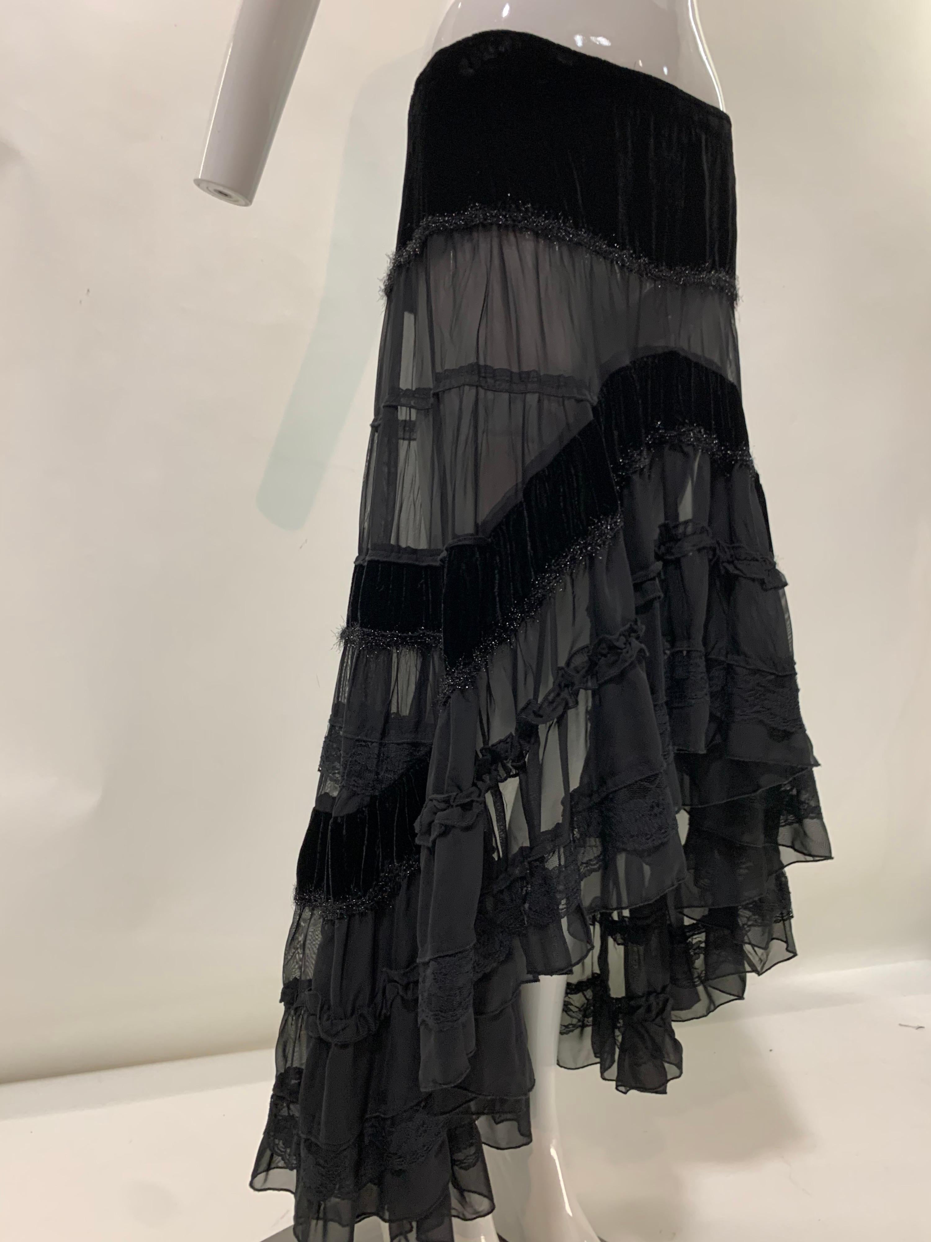 A fabulously Bohemian Torso Creations black silk chiffon, velvet and lace trimmed tiered peasant skirt with a hi/low hemline. Side zipper. Size 6.