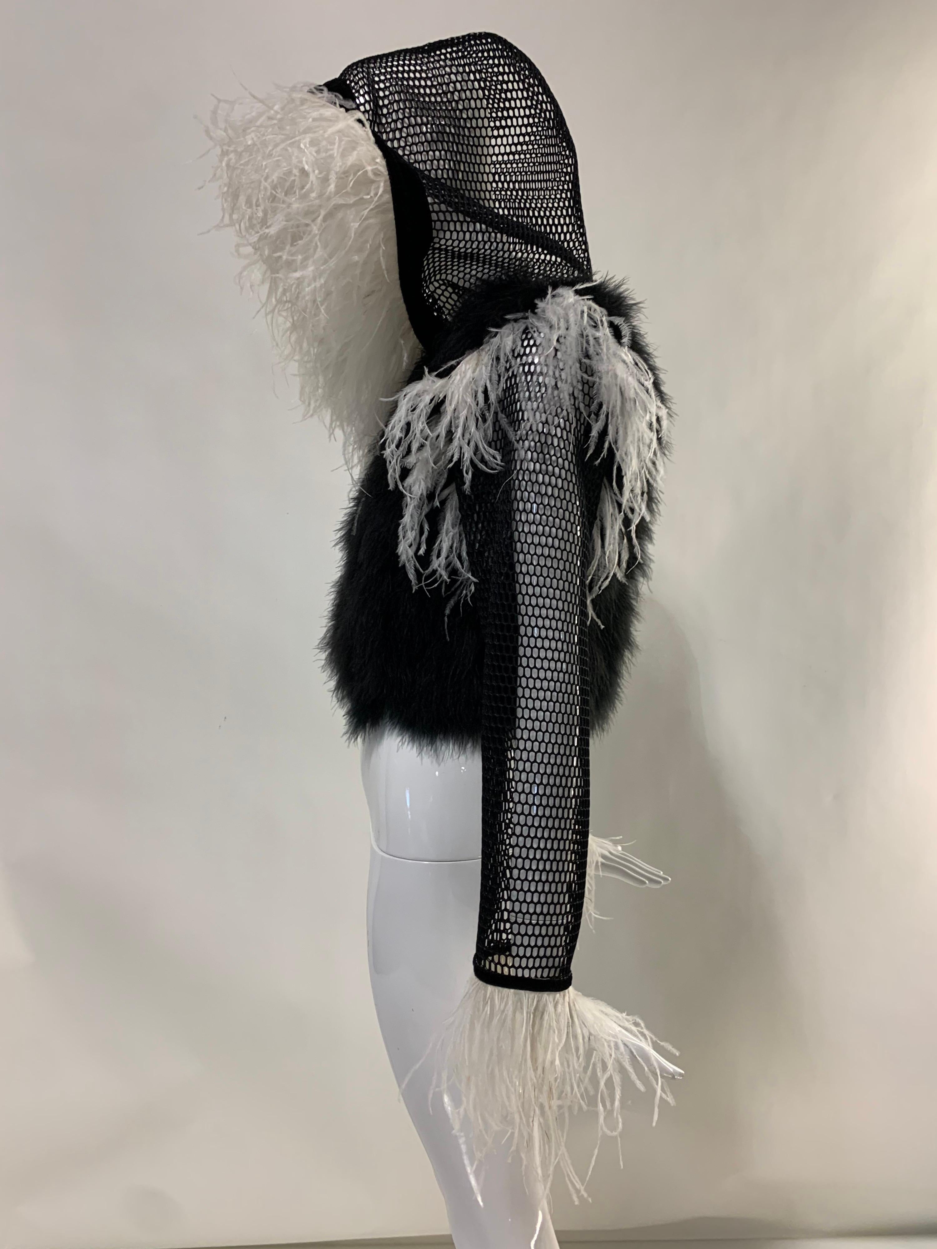 A Torso Creations original hoodie with extravagant ostrich trim in black and white: Body of jacket is black marabou feathers with black mesh hood and sleeves, lush white ostrich trim and checkerboard satin lining. Size 6.